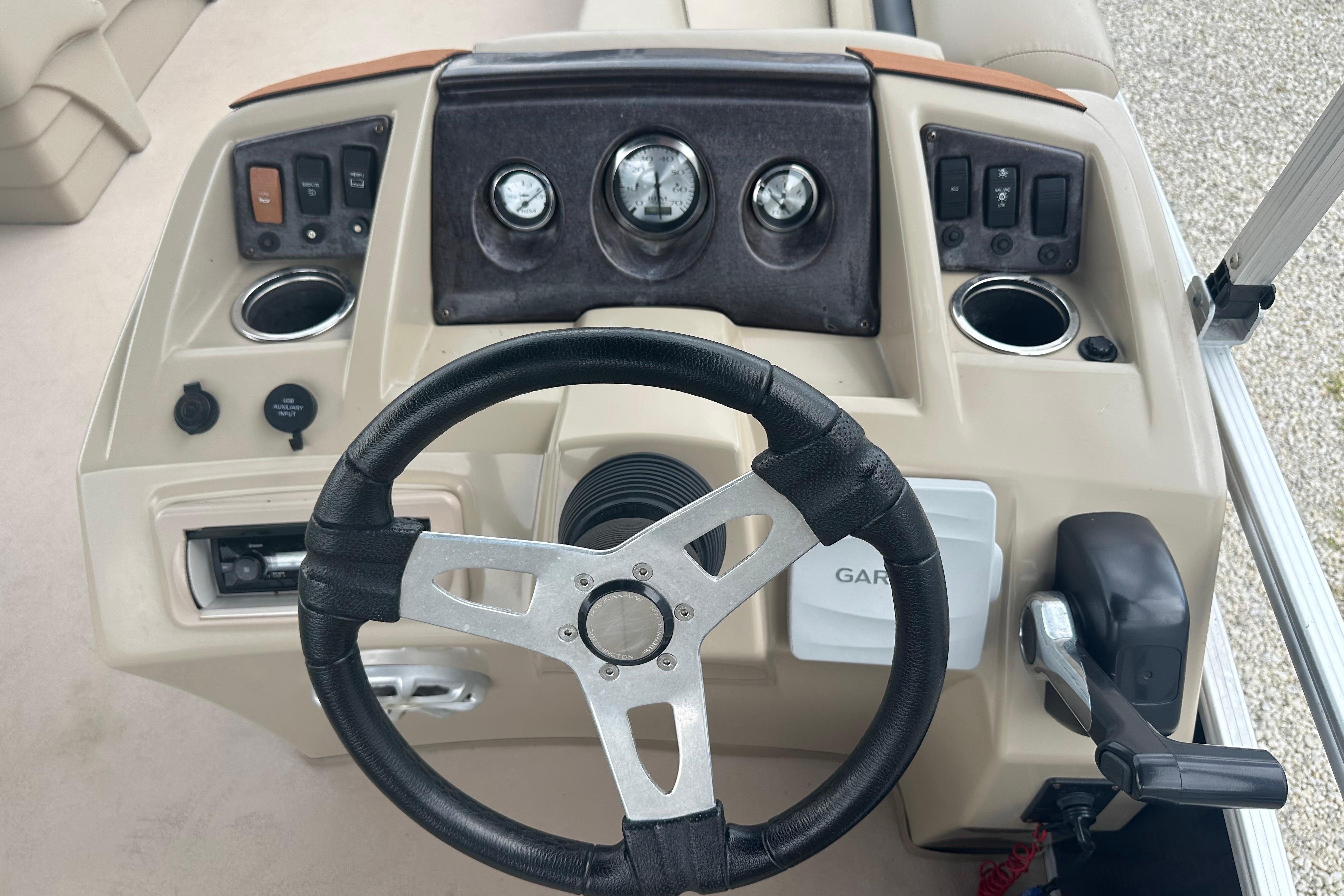Steering console of a 2014 Bennington S22 boat with gauges and controls.