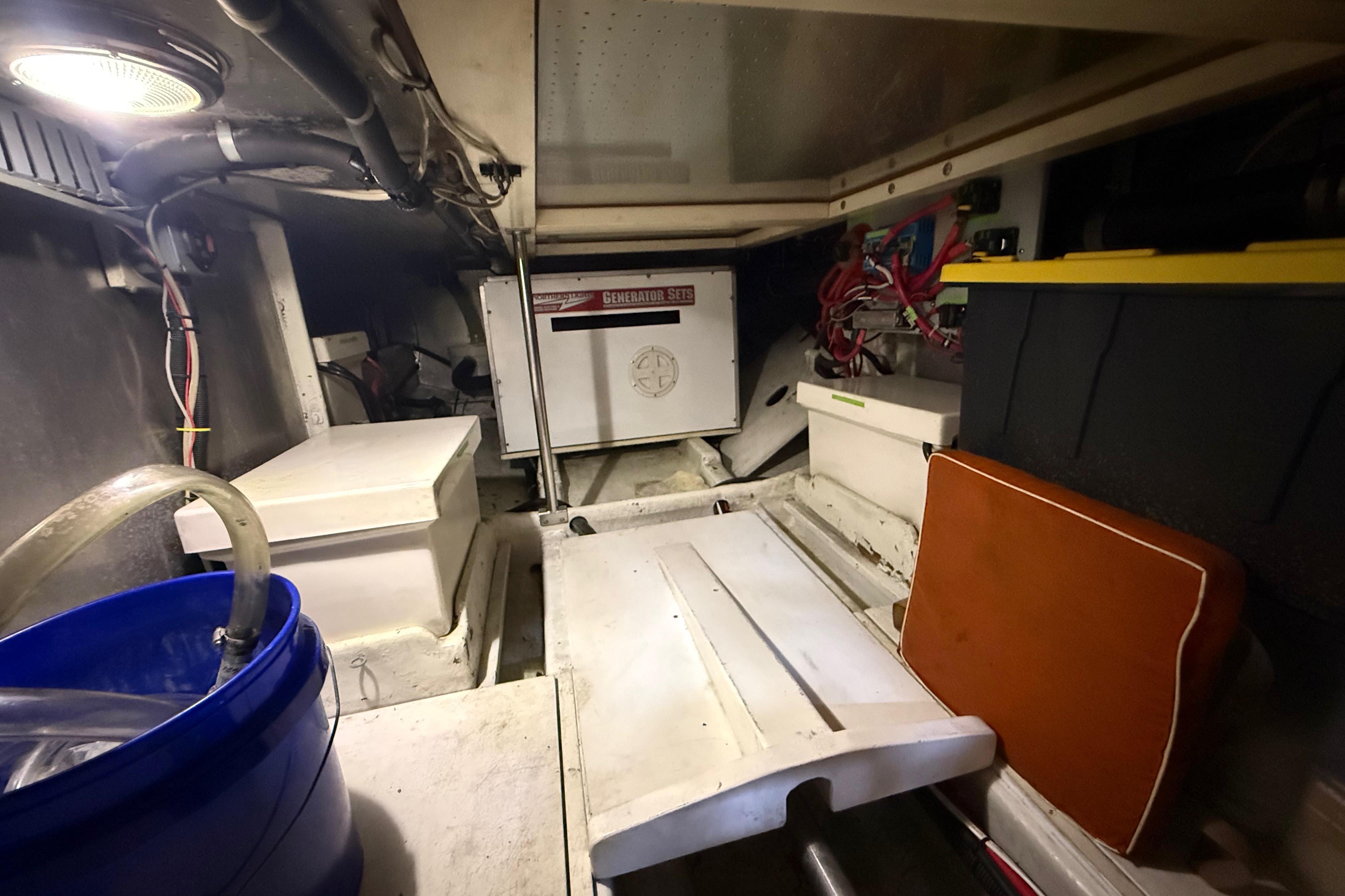 Engine room of a 2001 Kadey-Krogen 39 boat, featuring a generator and storage.
