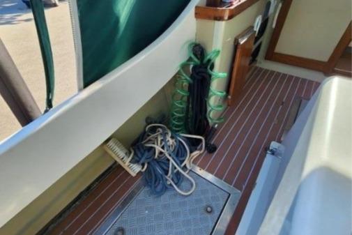 1985 Wasque Down East Cruiser deck with ropes and coiled hoses.