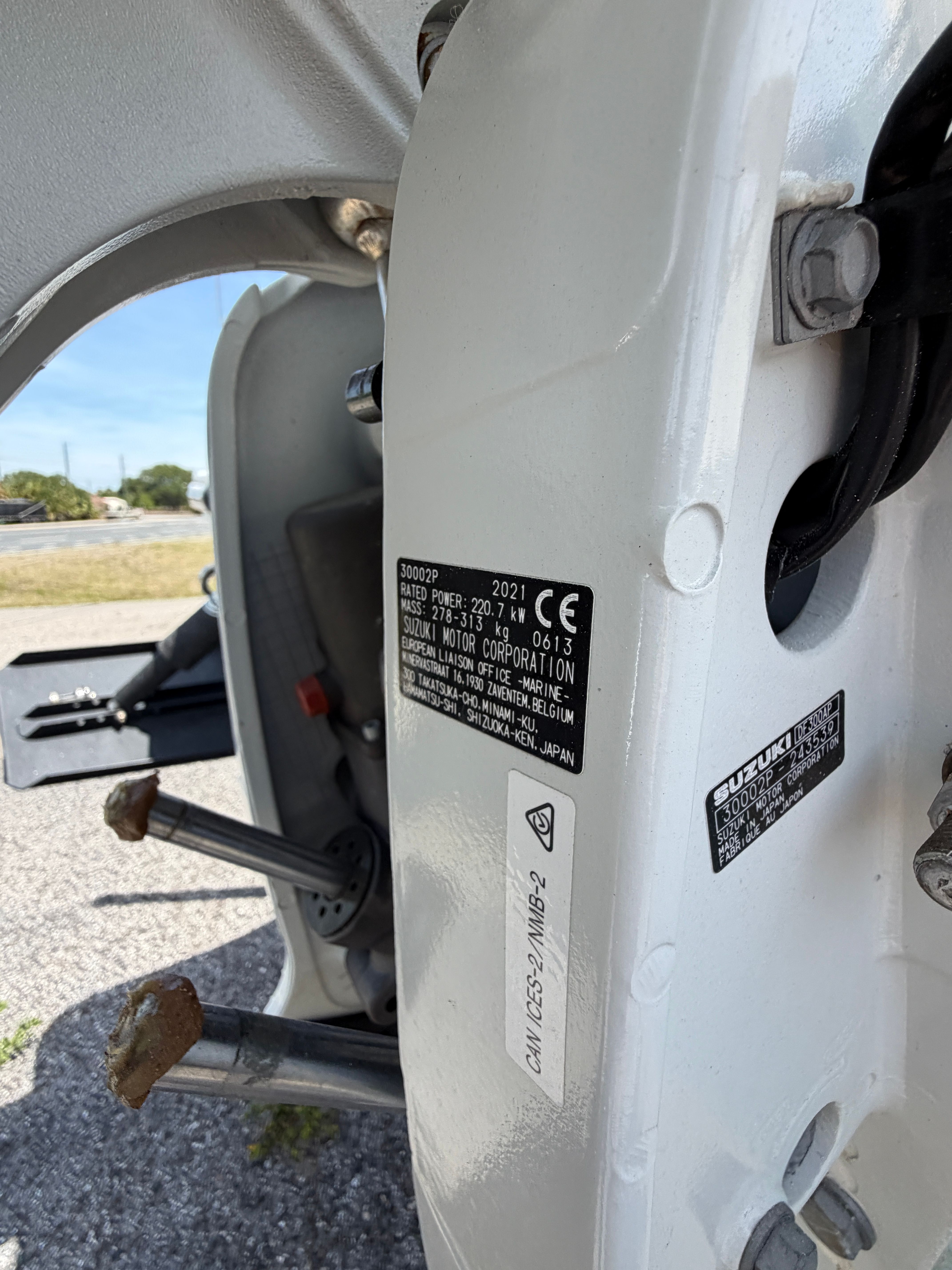 Close-up of a Suzuki outboard motor on a McKee Craft boat.