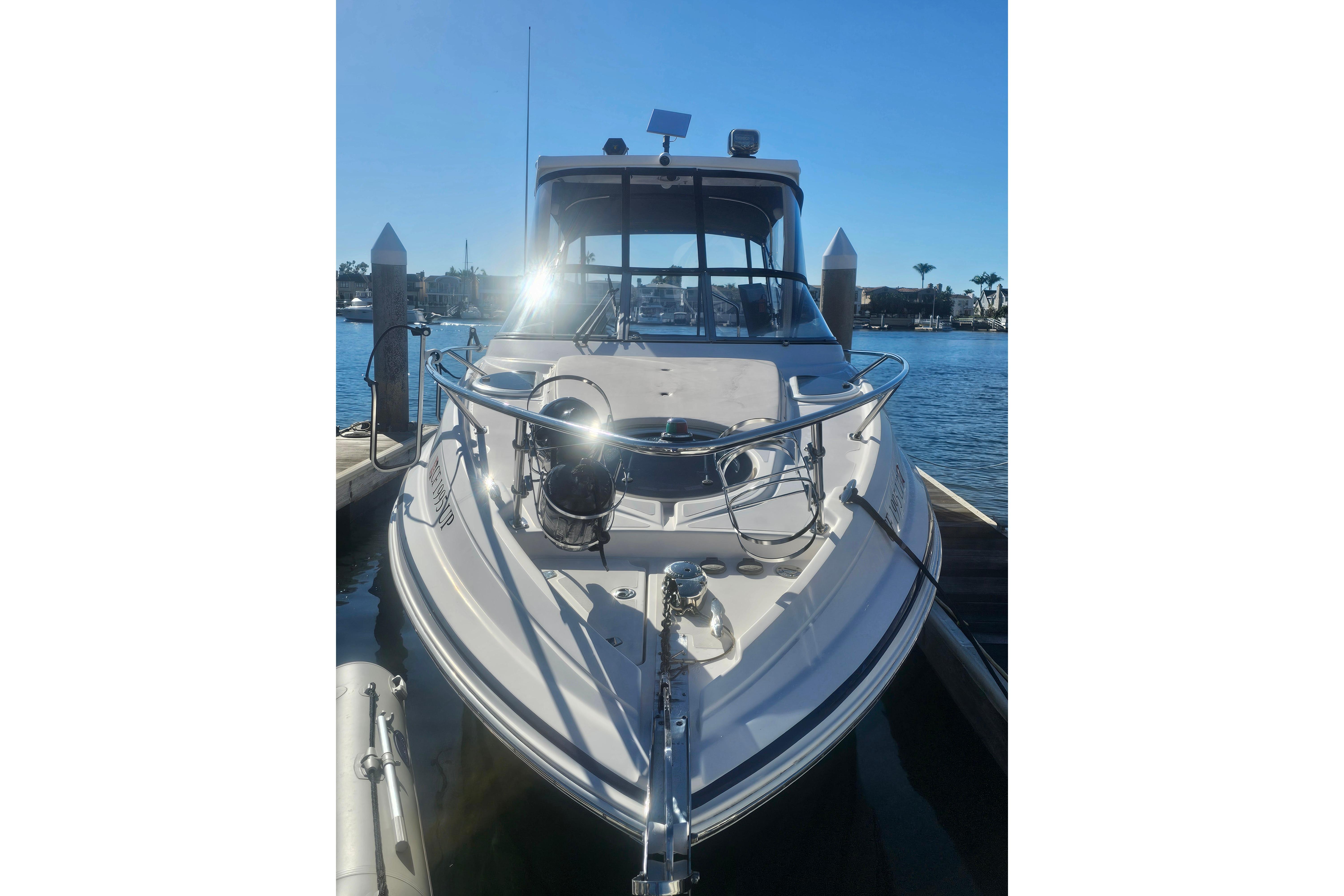 2013 Regal 28 Express boat docked in sunny marina setting.