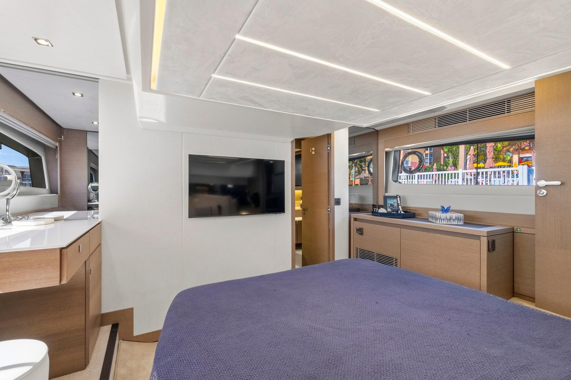 Luxurious interior of 2022 Prestige 520 yacht with modern furnishings and large windows.