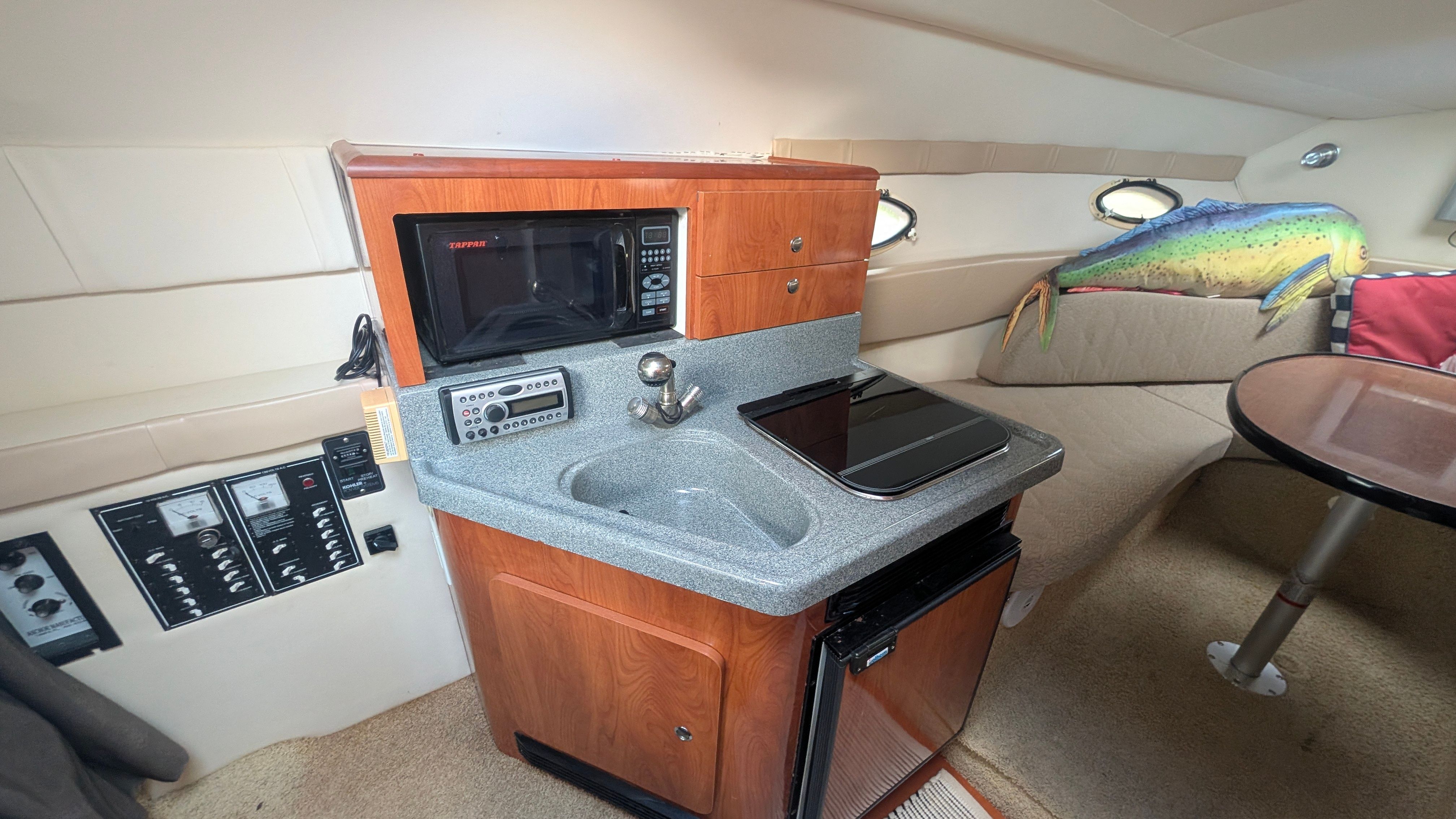 Interior of the 2006 Larson Cabrio 274 with kitchenette and seating area.