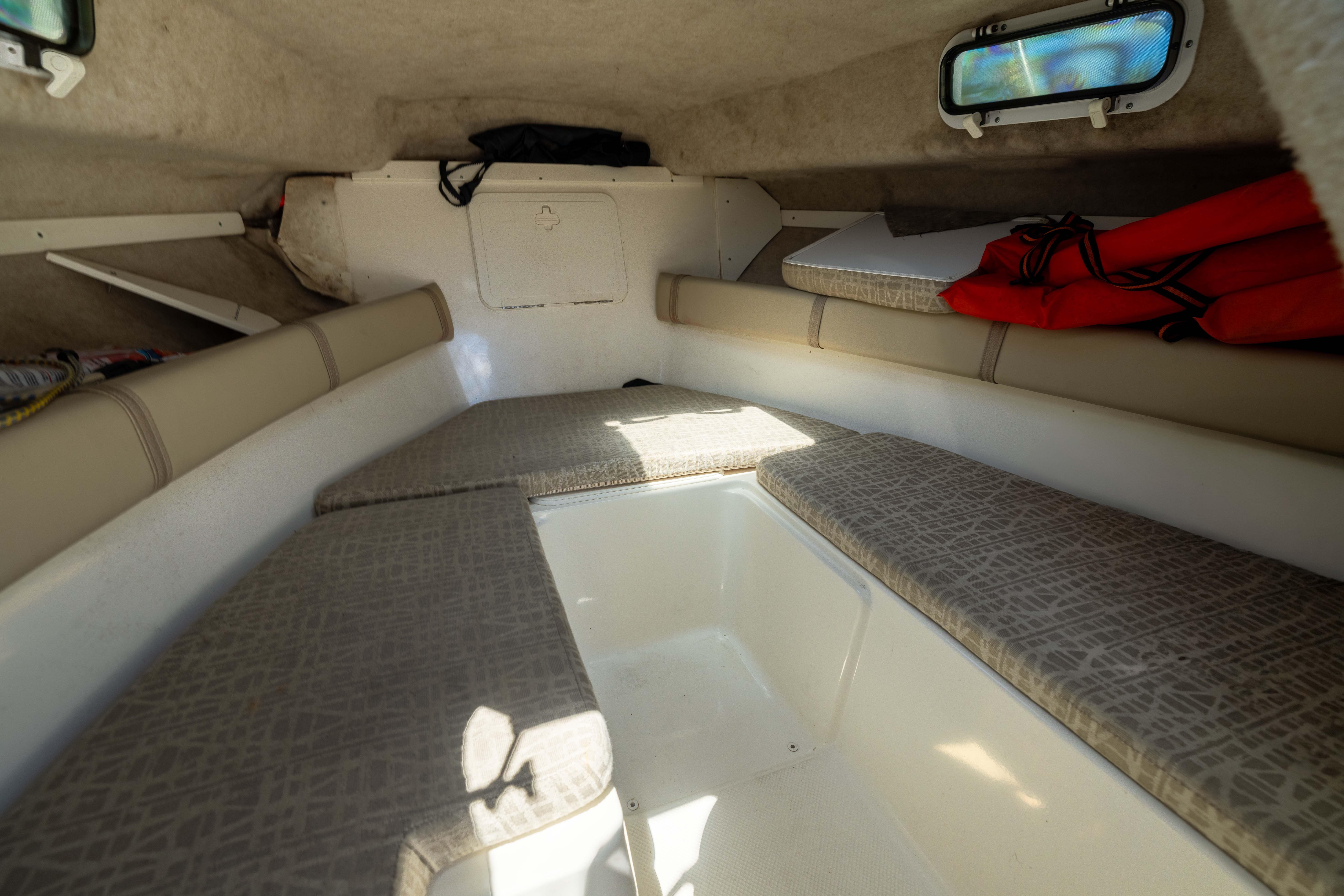 Interior cabin of a 2012 KEYWEST 2020 WA boat with cushioned seating and life jackets.