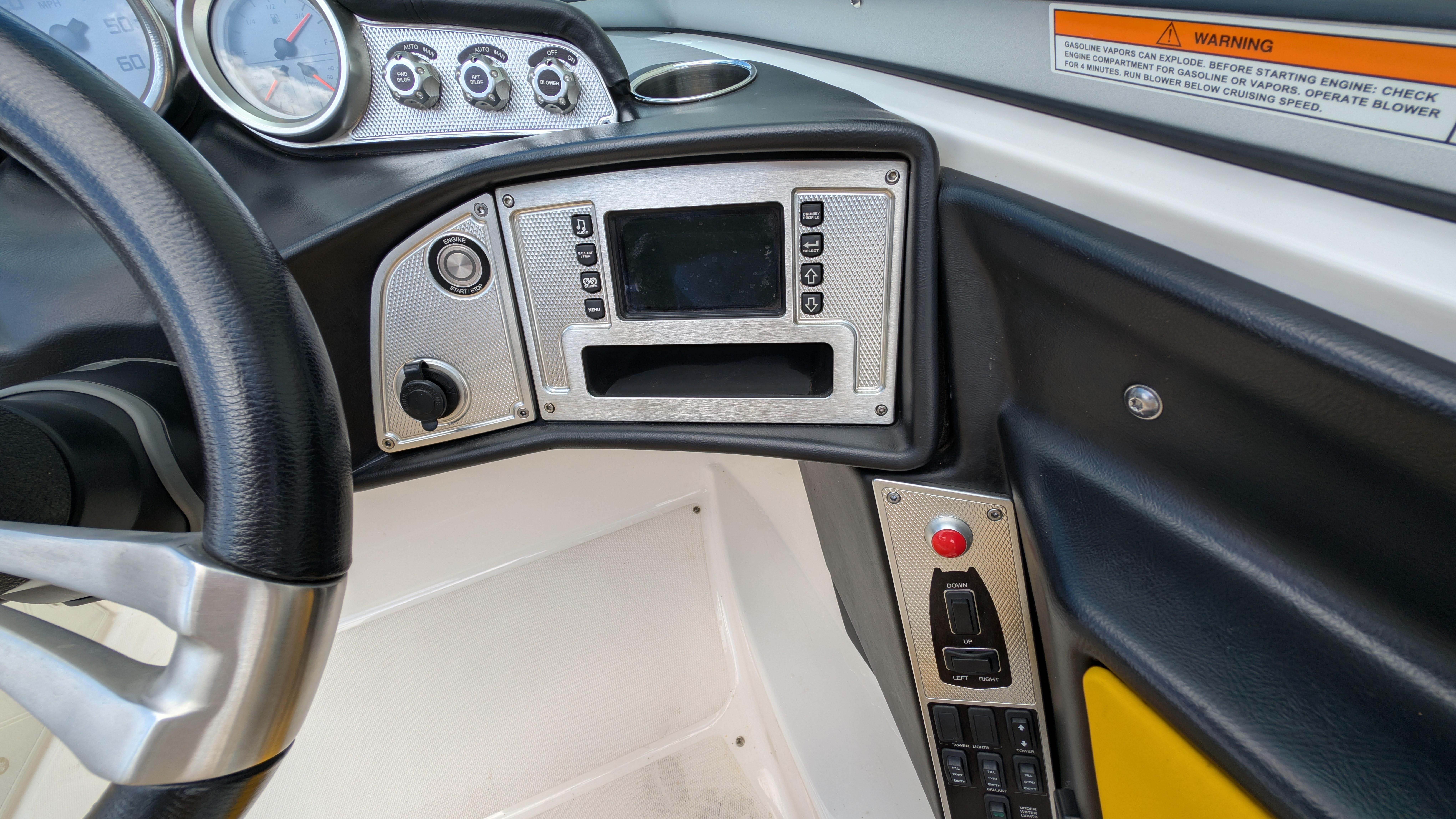 Dashboard of a 2013 MasterCraft X2 boat with steering wheel and control panel.