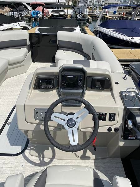 The image shows the cockpit of a 2020 Xcursion 243 RFX with a modern helm.