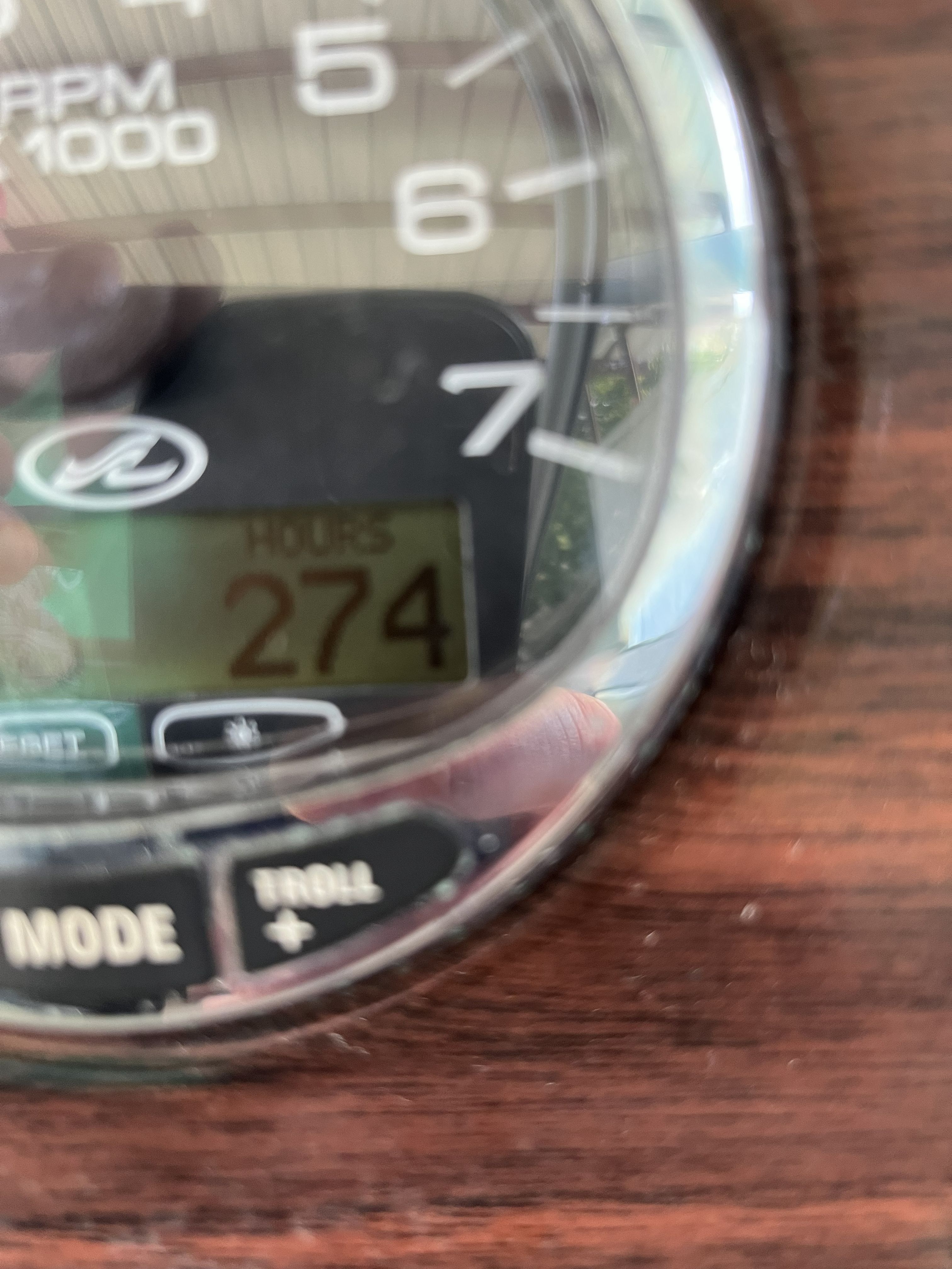 Close-up of a boat dashboard with an hour meter showing 274 hours.