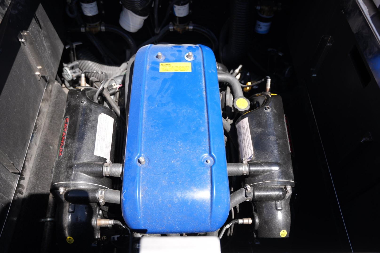 Engine compartment of a 2016 Supreme S211 boat, featuring a blue engine cover.