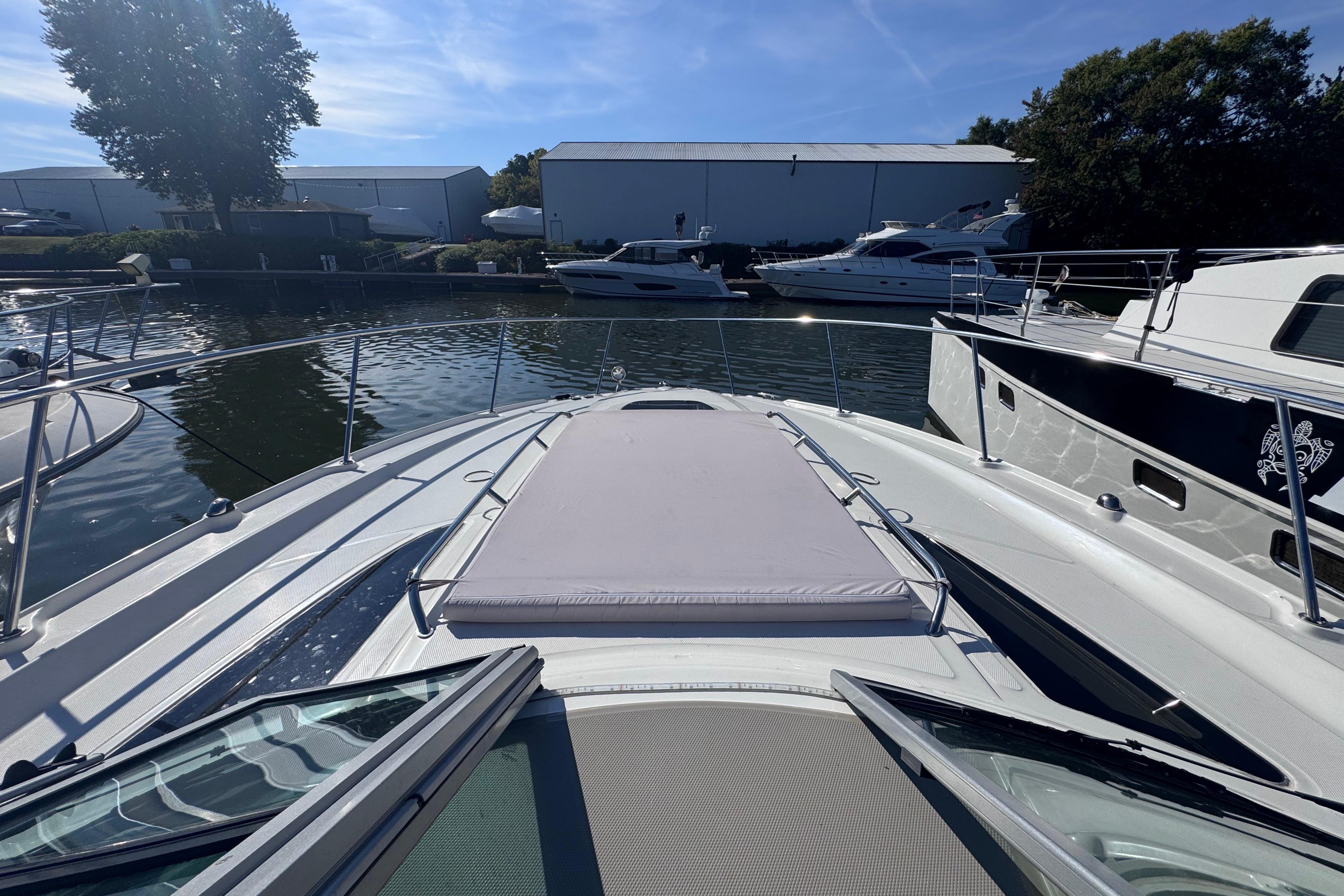 2008 Sea Ray 350 Sundancer yacht docked in a marina under clear blue skies.