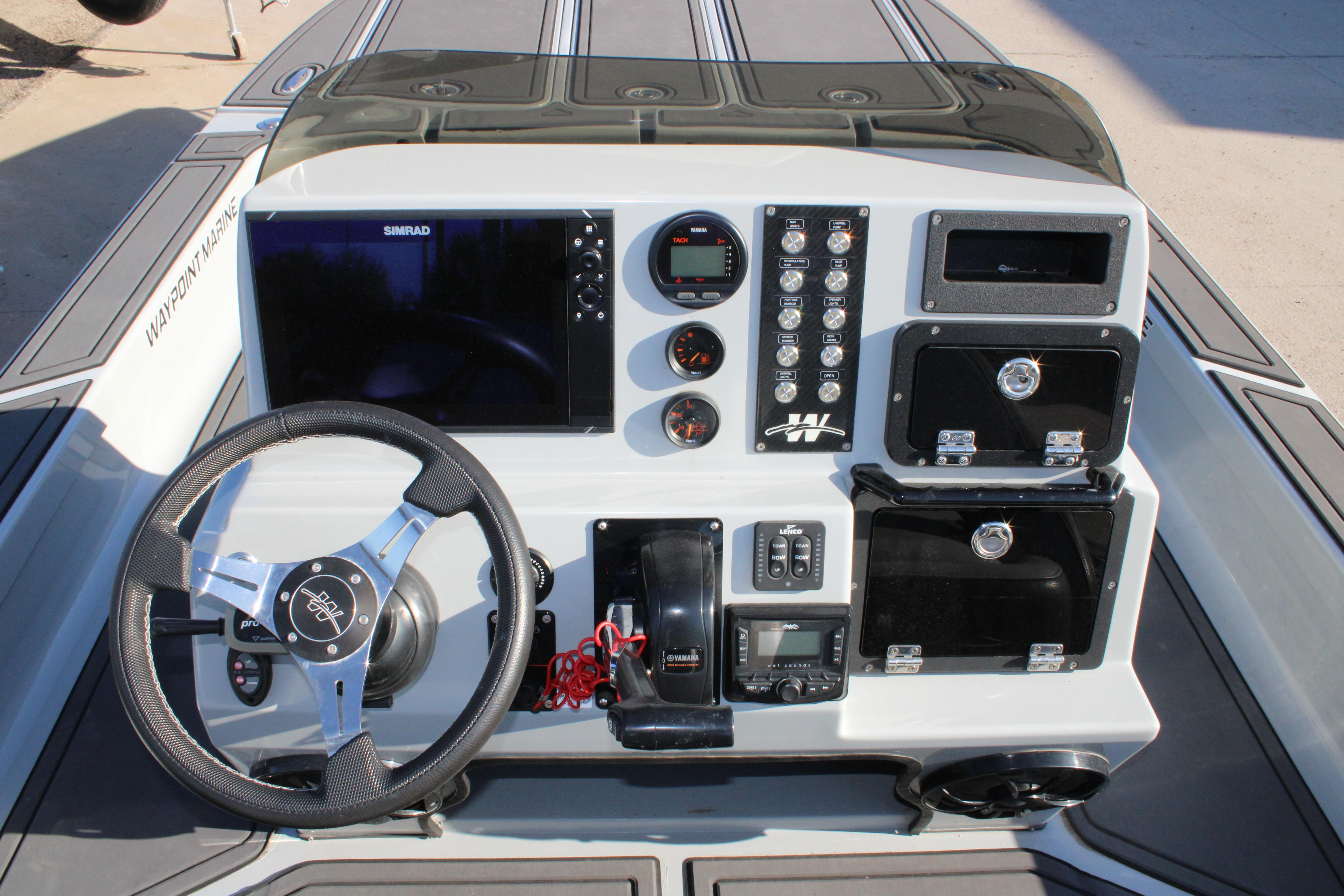 Control panel of 2025 Mamba 227VX boat with steering wheel and navigation system.