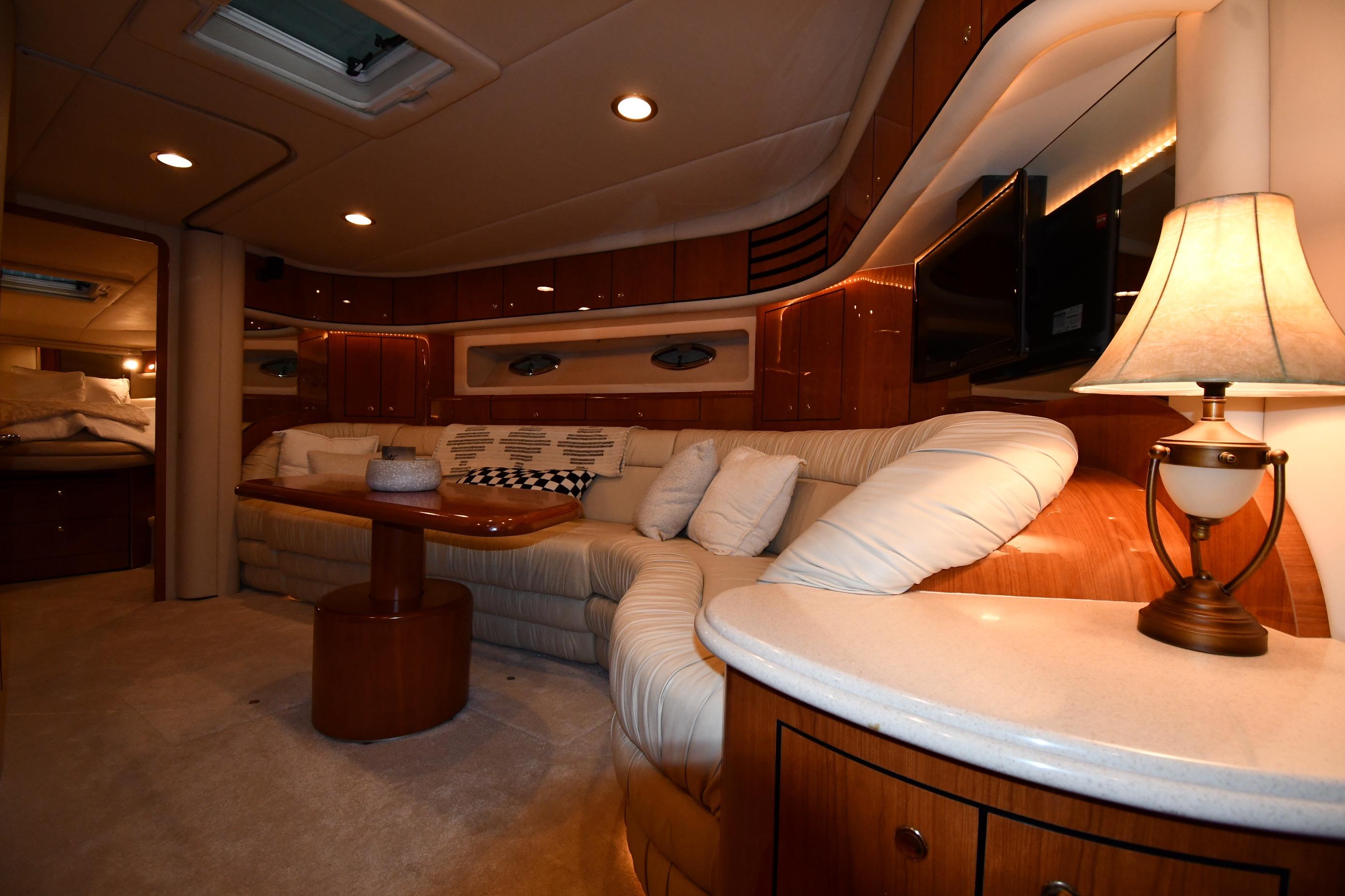 Luxurious interior of 2001 Sea Ray 540 Sundancer yacht with plush seating and elegant lighting.