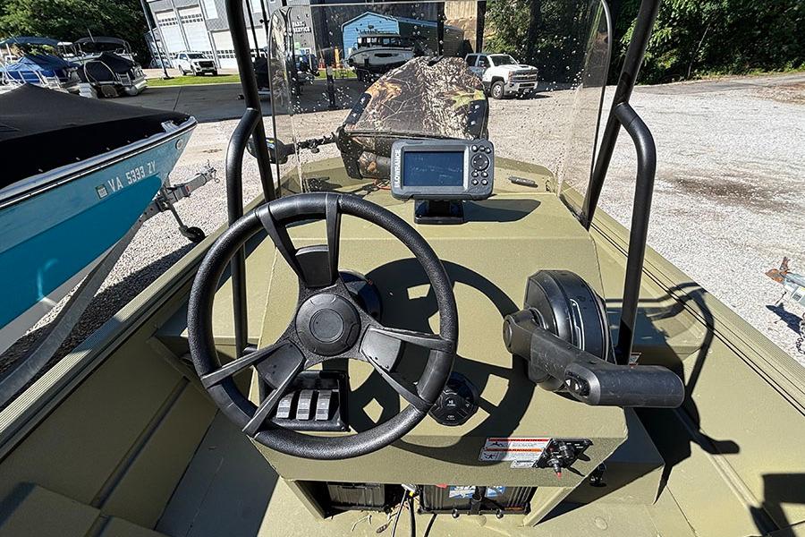 2022 Lowe Roughneck 1660 boat dashboard with steering wheel and navigation system.