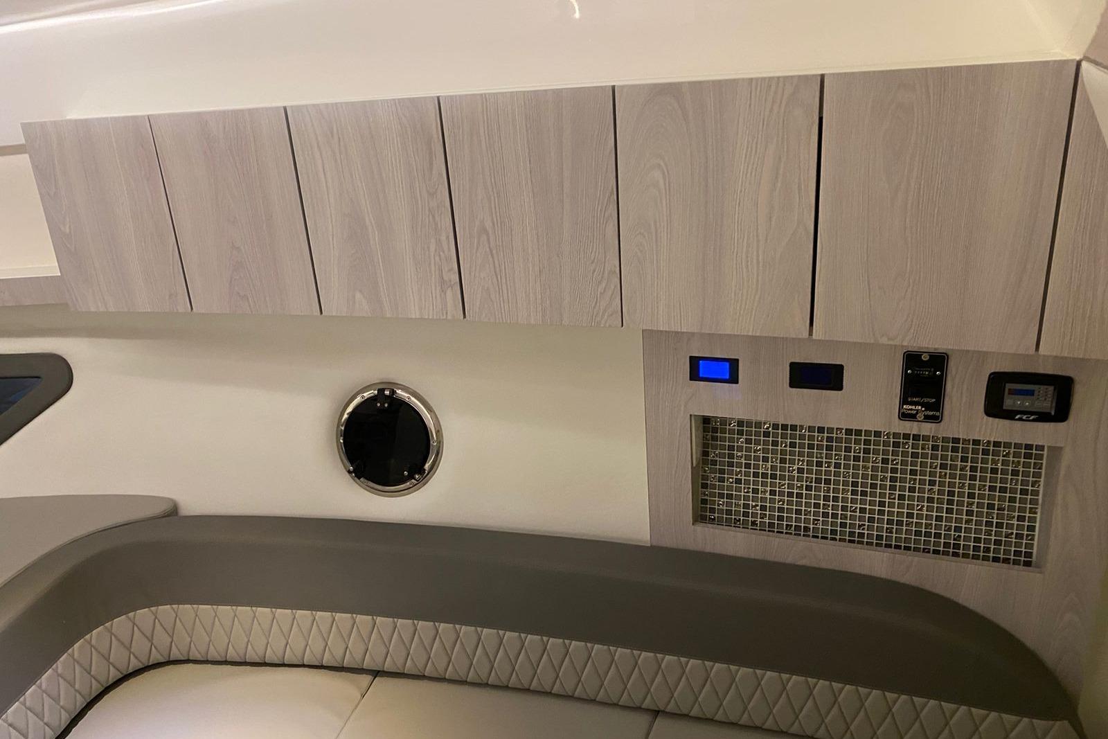 Interior of 2026 Hanover 375 boat with modern cabinetry and control panel.