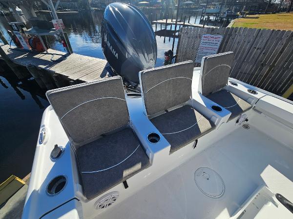 2026 Sea Hunt BX 22 BR boat with three cushioned seats and Yamaha engine at dock.