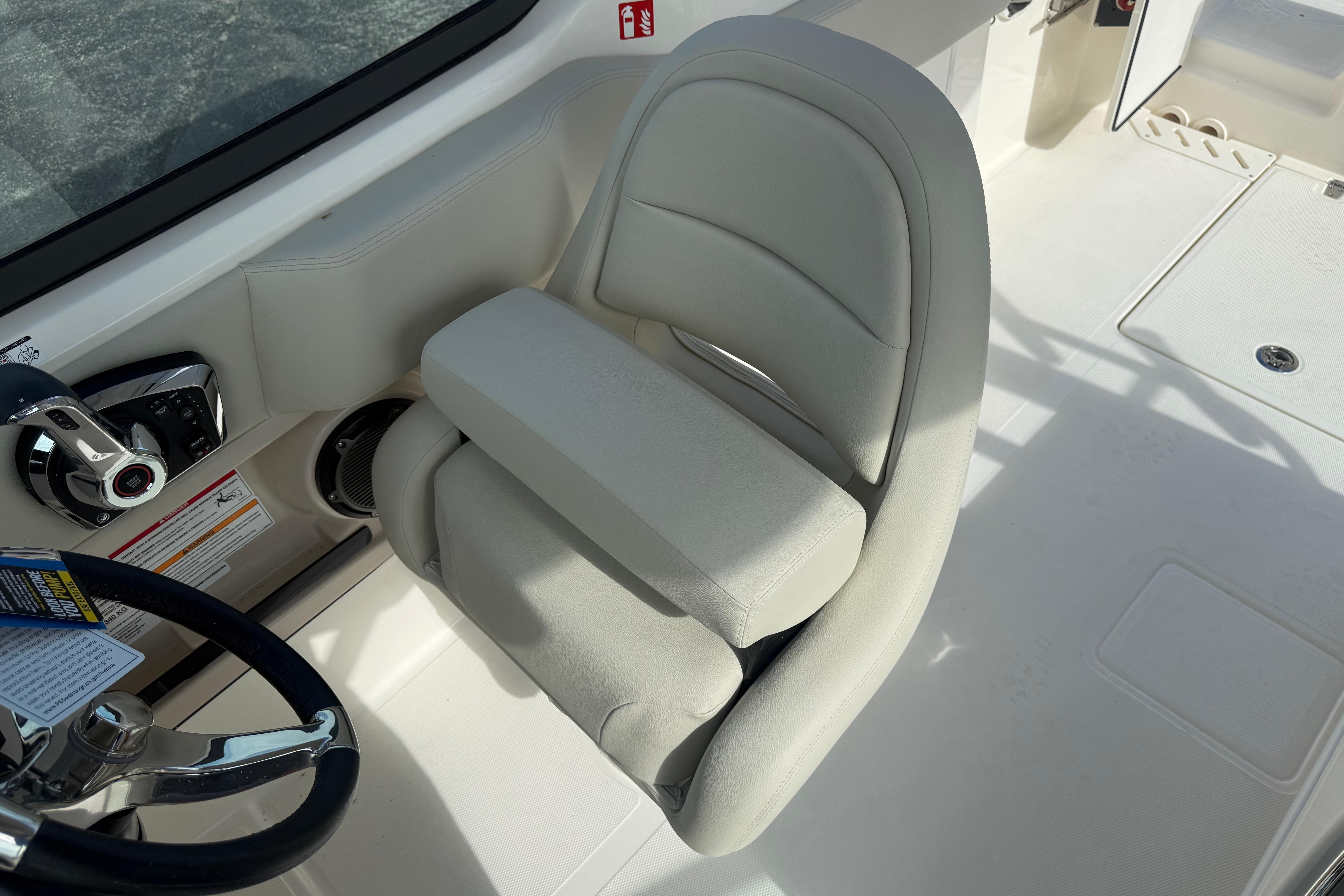 Captain's seat on 2026 Boston Whaler 240 Vantage boat, featuring sleek design and controls.