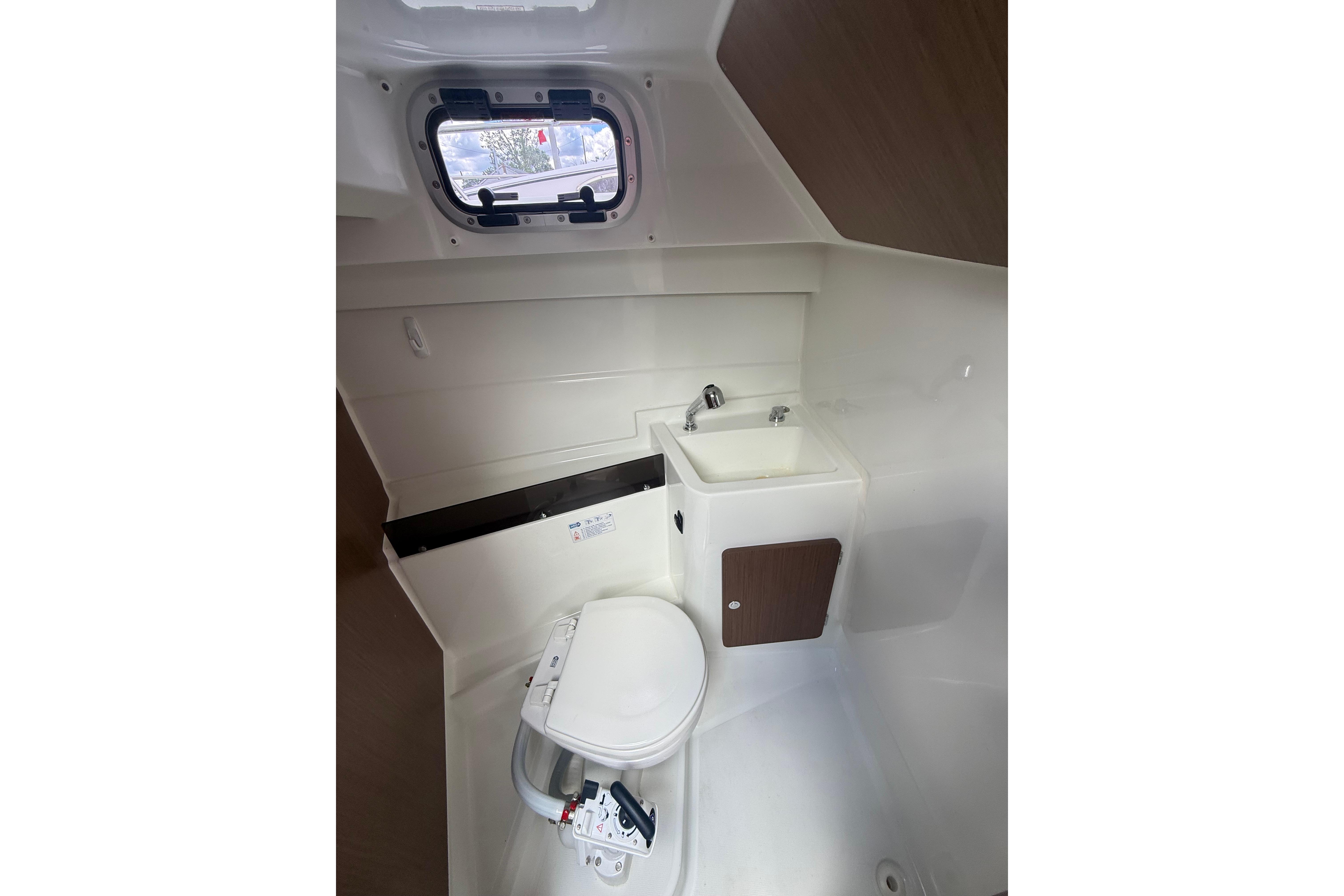 Bathroom interior of 2019 Beneteau Antares 23 boat with sink and toilet.