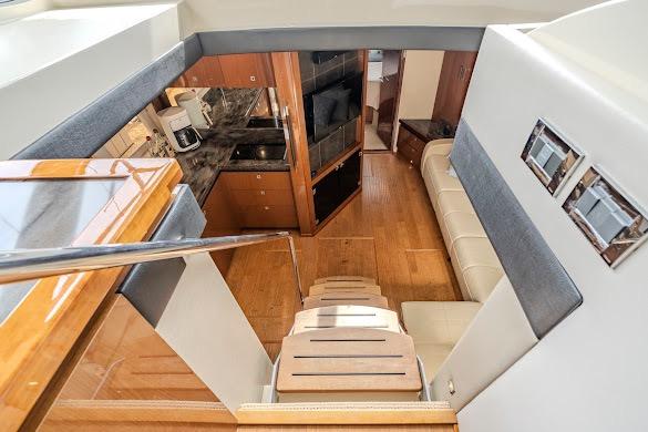 Interior of 2016 Sea Ray Sundancer 510 yacht with modern kitchen and seating area.