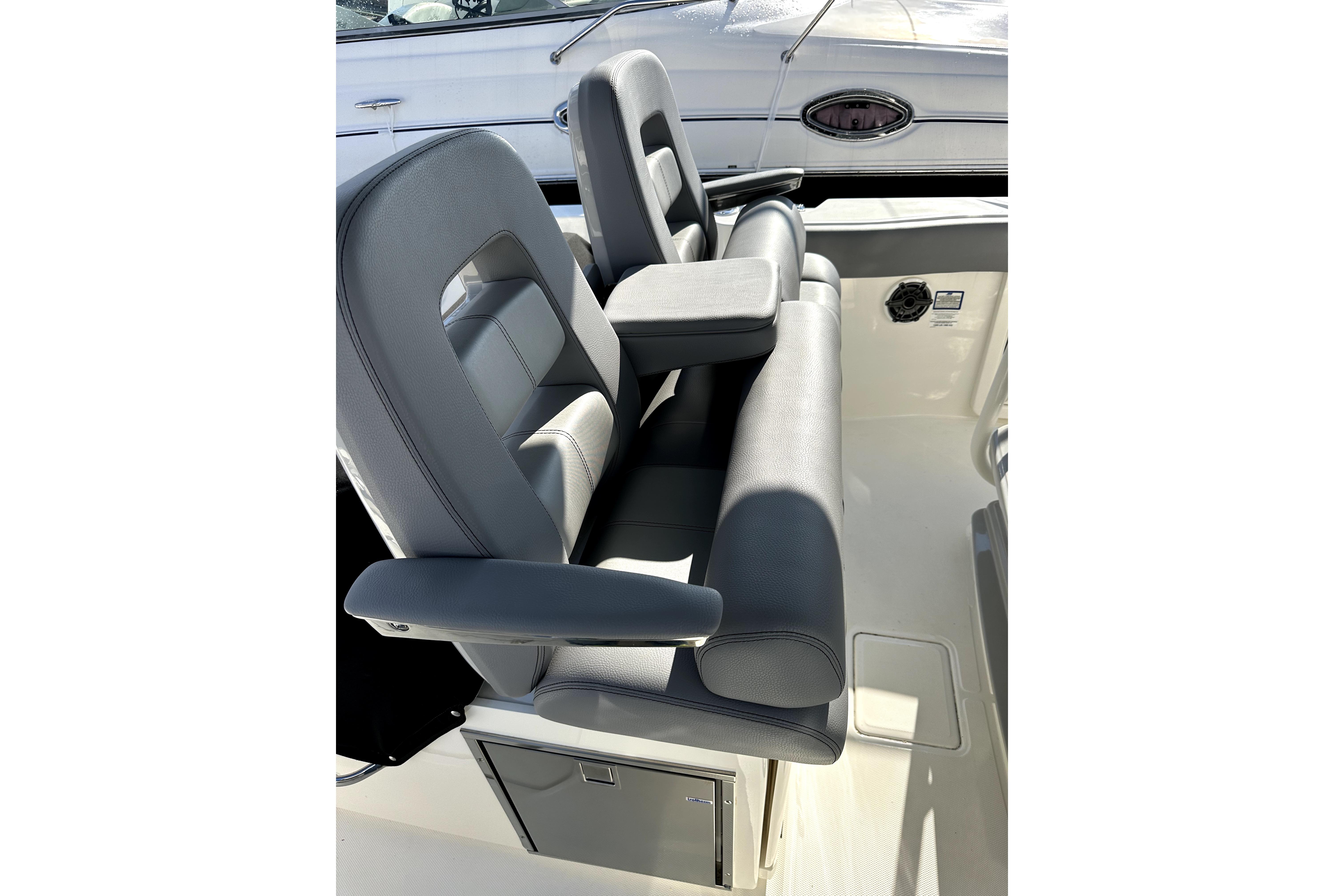 2023 Boston Whaler OUTRAGE boat interior with gray seating and armrests.