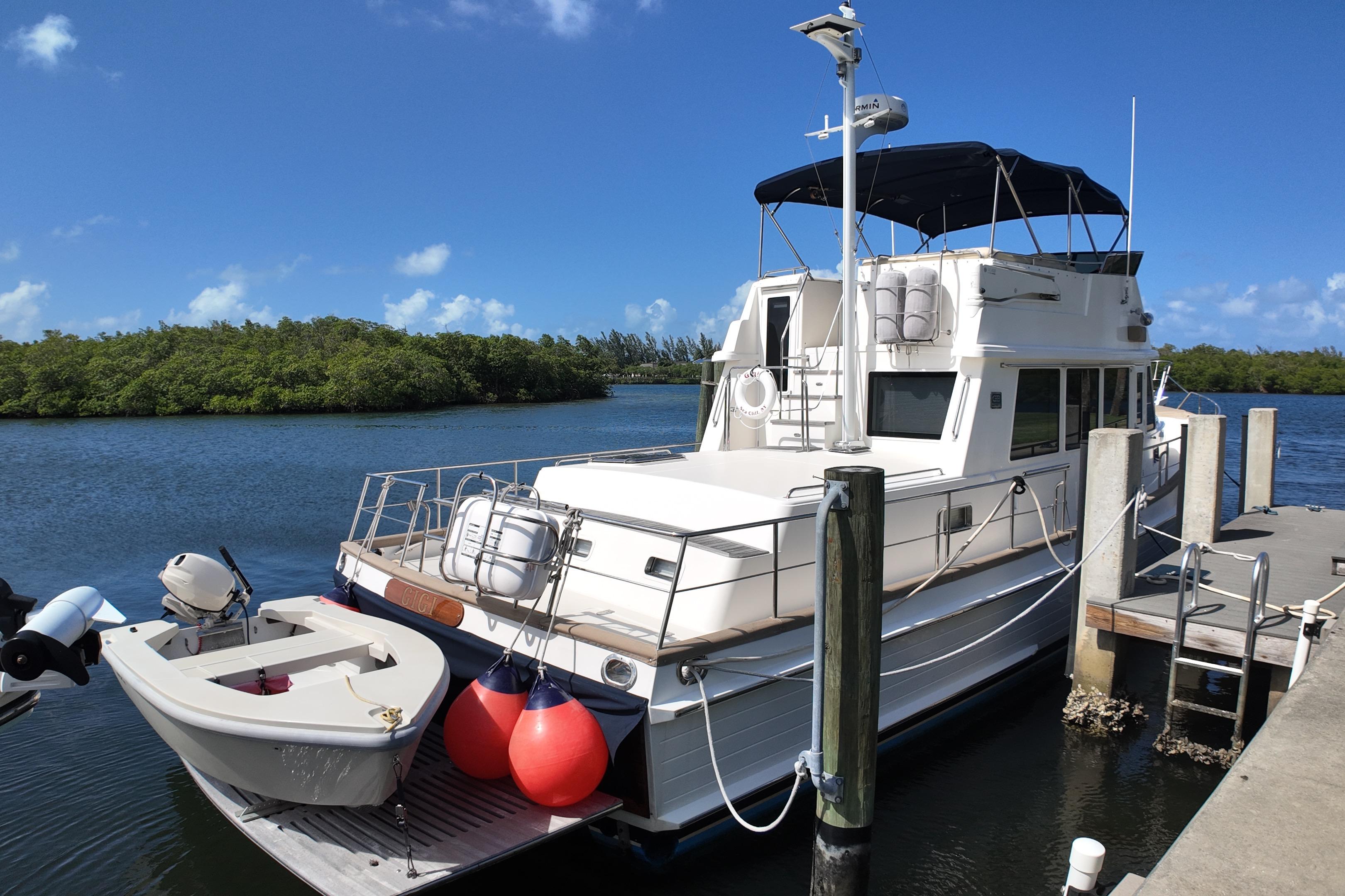 2009 Grand Banks 47 Heritage CL yacht docked by a serene waterway.