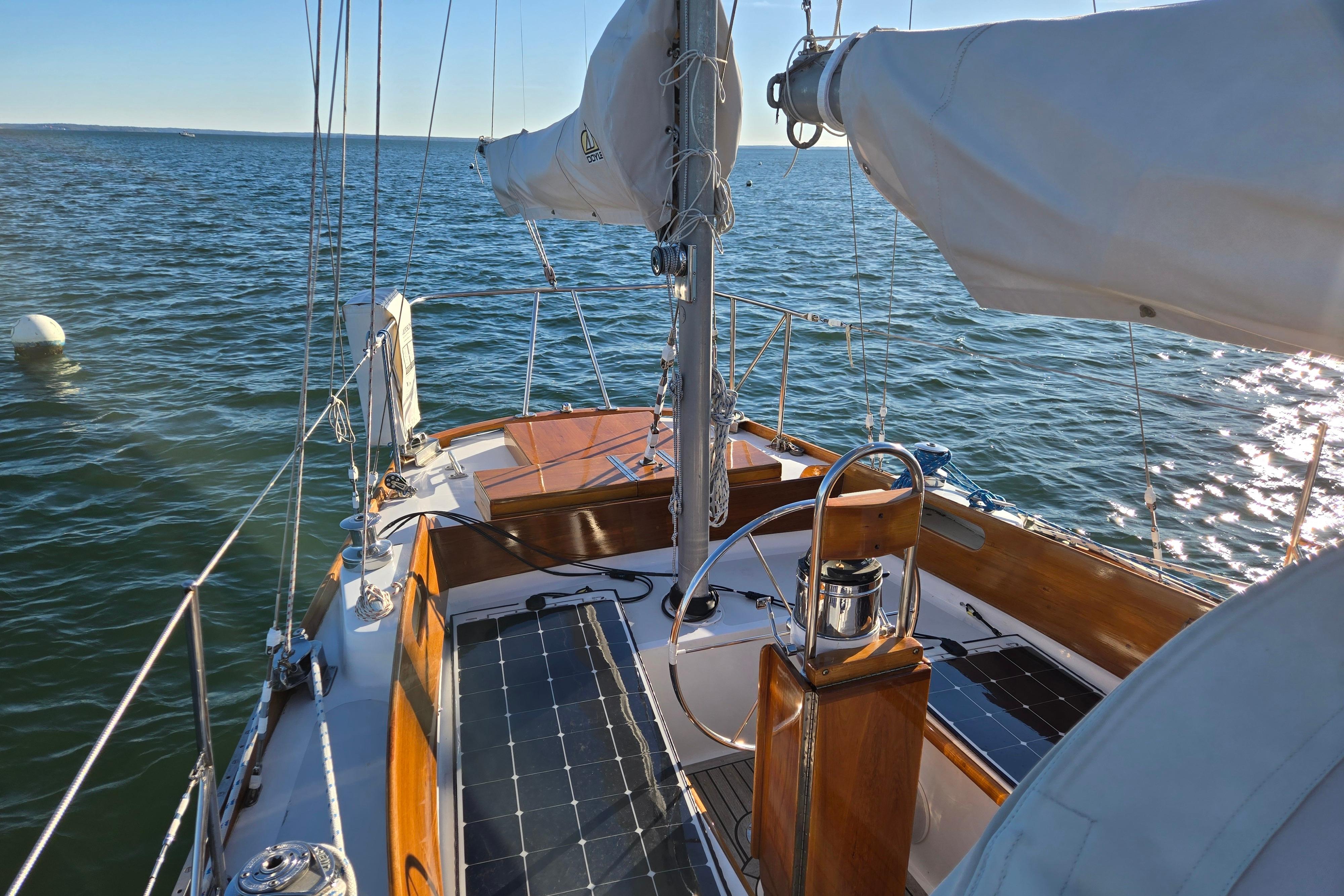 1970 Hinckley Bermuda 40 sailboat on calm ocean waters, sunny day.
