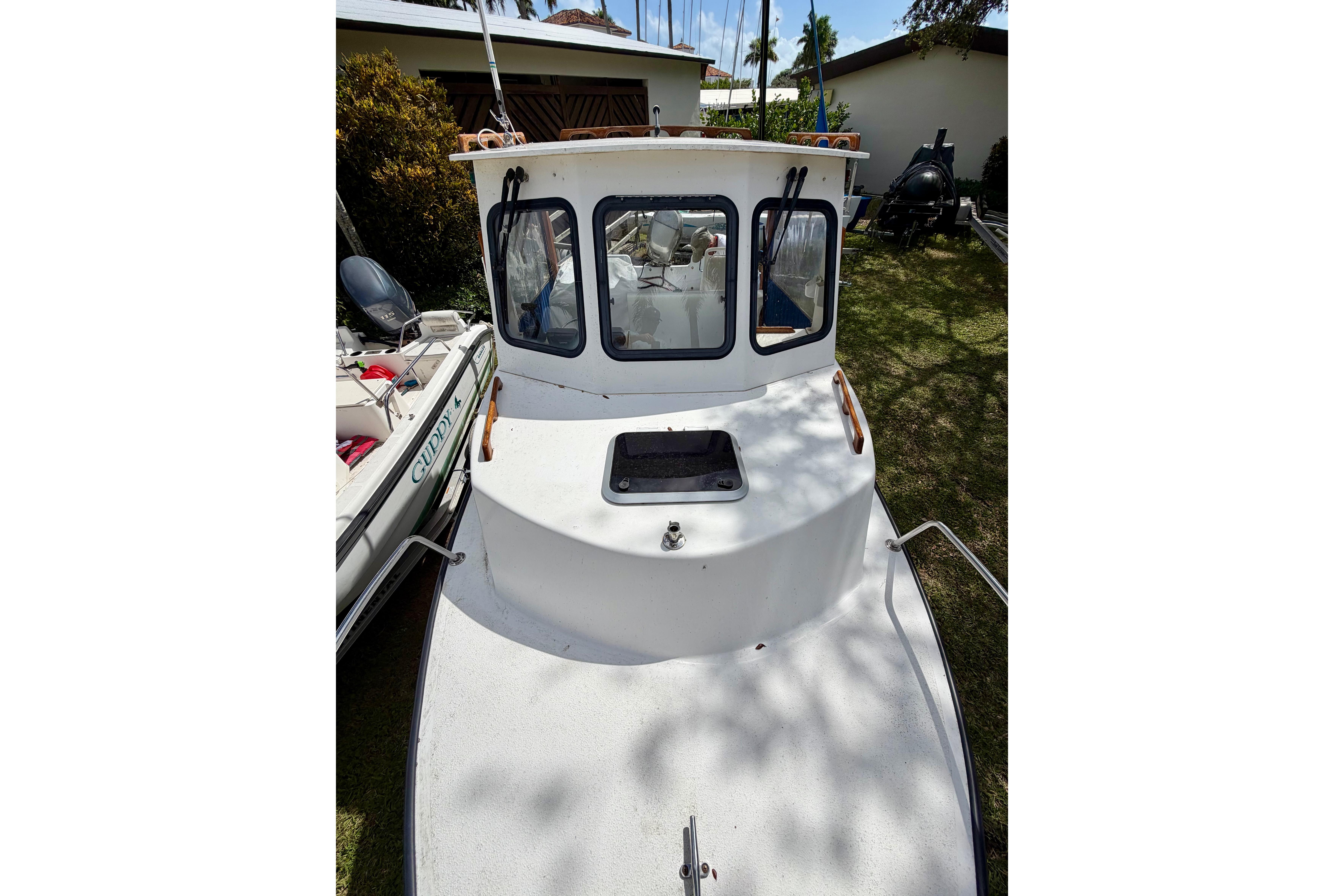 2000 Eastern 22 Lobster Fisherman boat, white exterior, docked on grass.