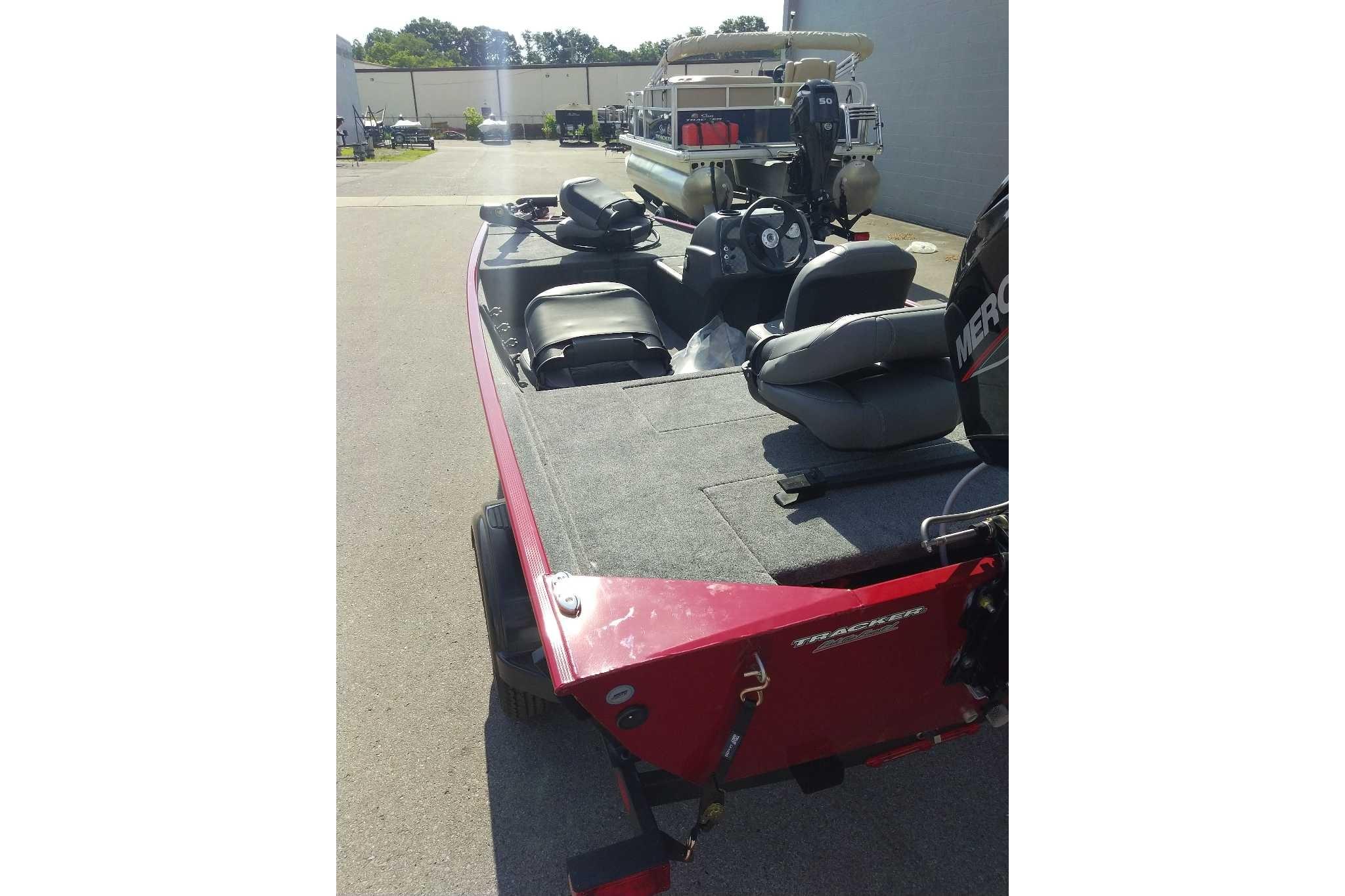 2026 Tracker Bass Tracker Classic XL boat with seating and Mercury engine, parked outdoors.