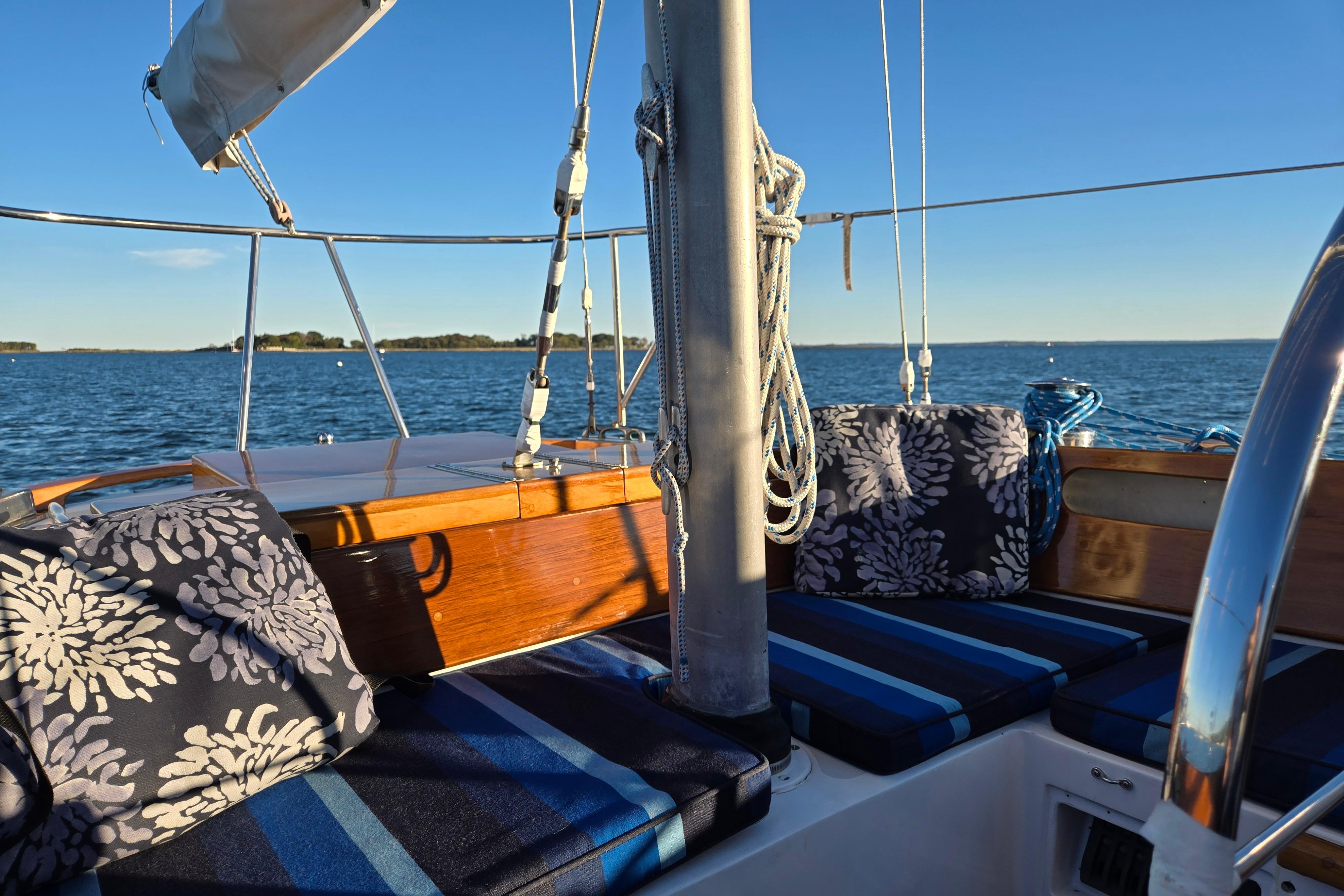 Hinckley Bermuda 40 sailboat interior with cushions, sailing on a sunny day, 1970 model.