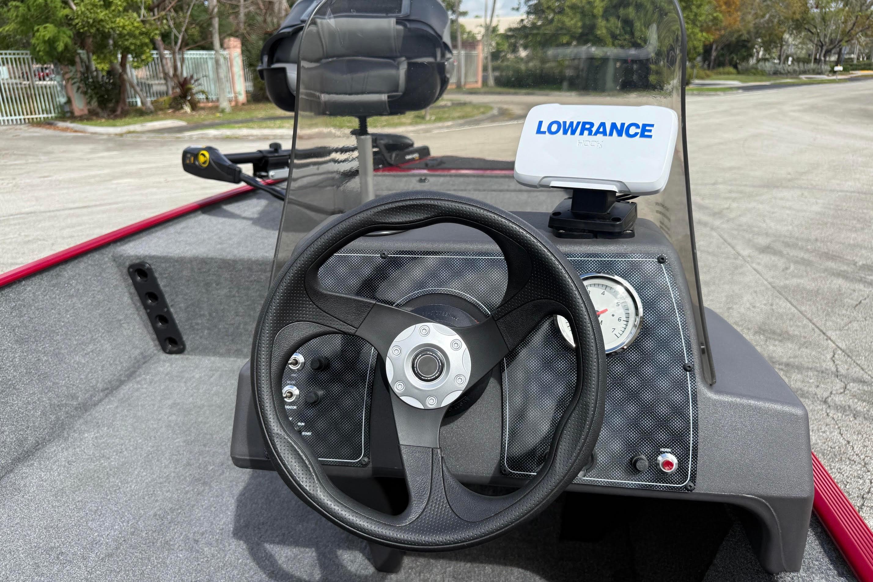 2023 Bass Tracker III Classic boat dashboard with steering wheel and Lowrance fish finder.