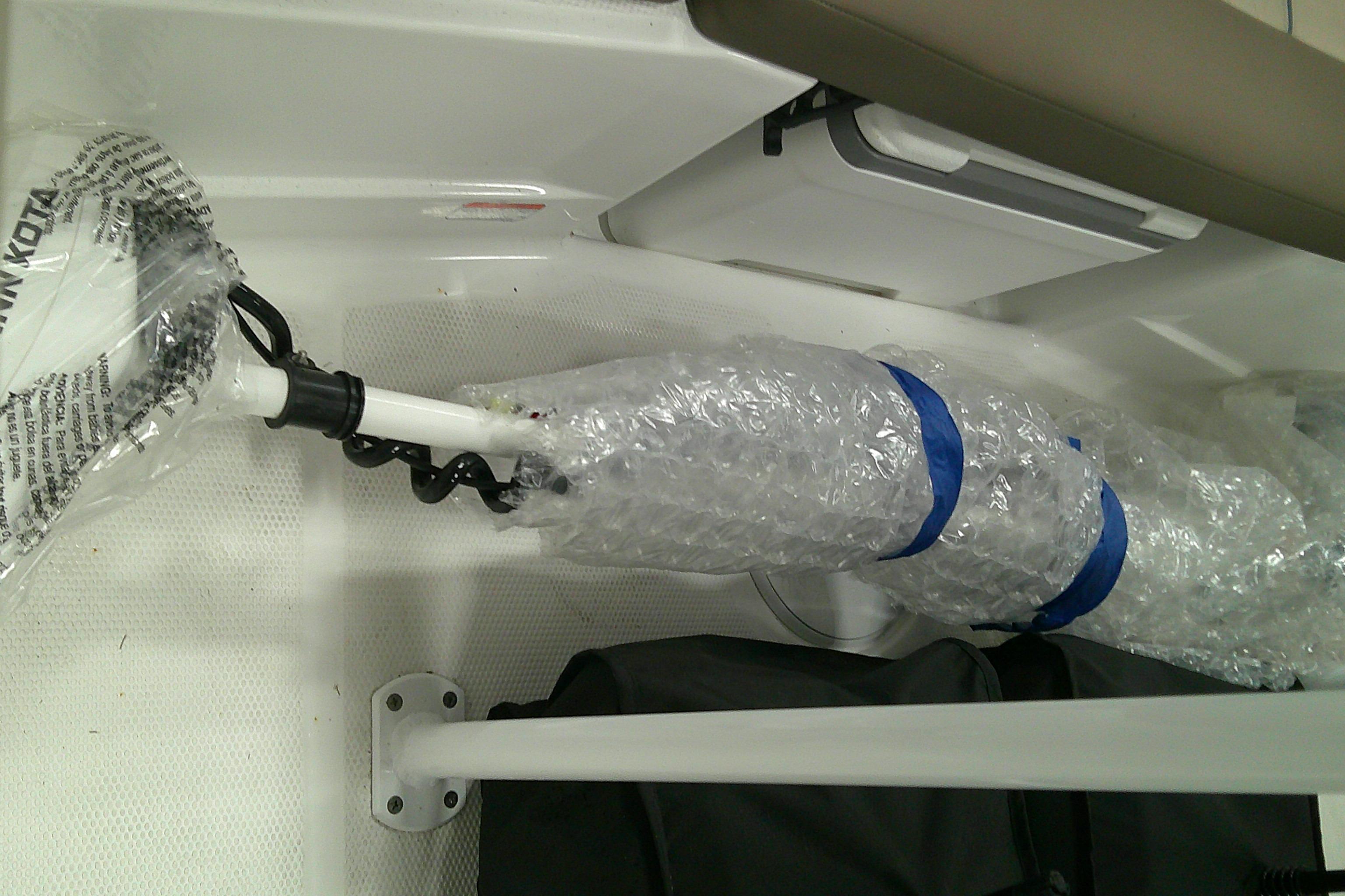 2026 Tahoe 2150 CC boat interior with wrapped equipment and storage compartment.