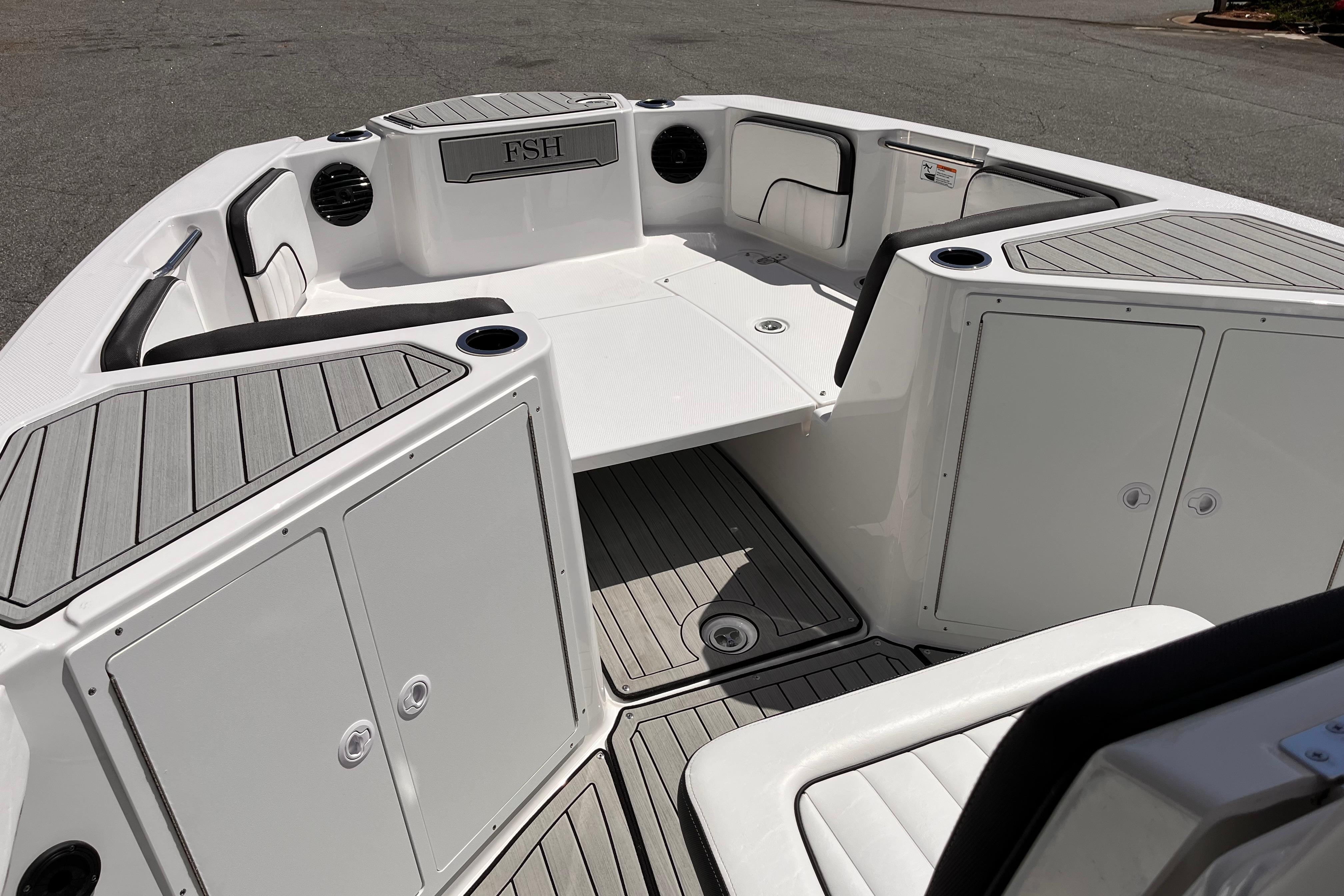 2026 Yamaha Boats 222 FSH Sport E interior with seating and storage compartments.