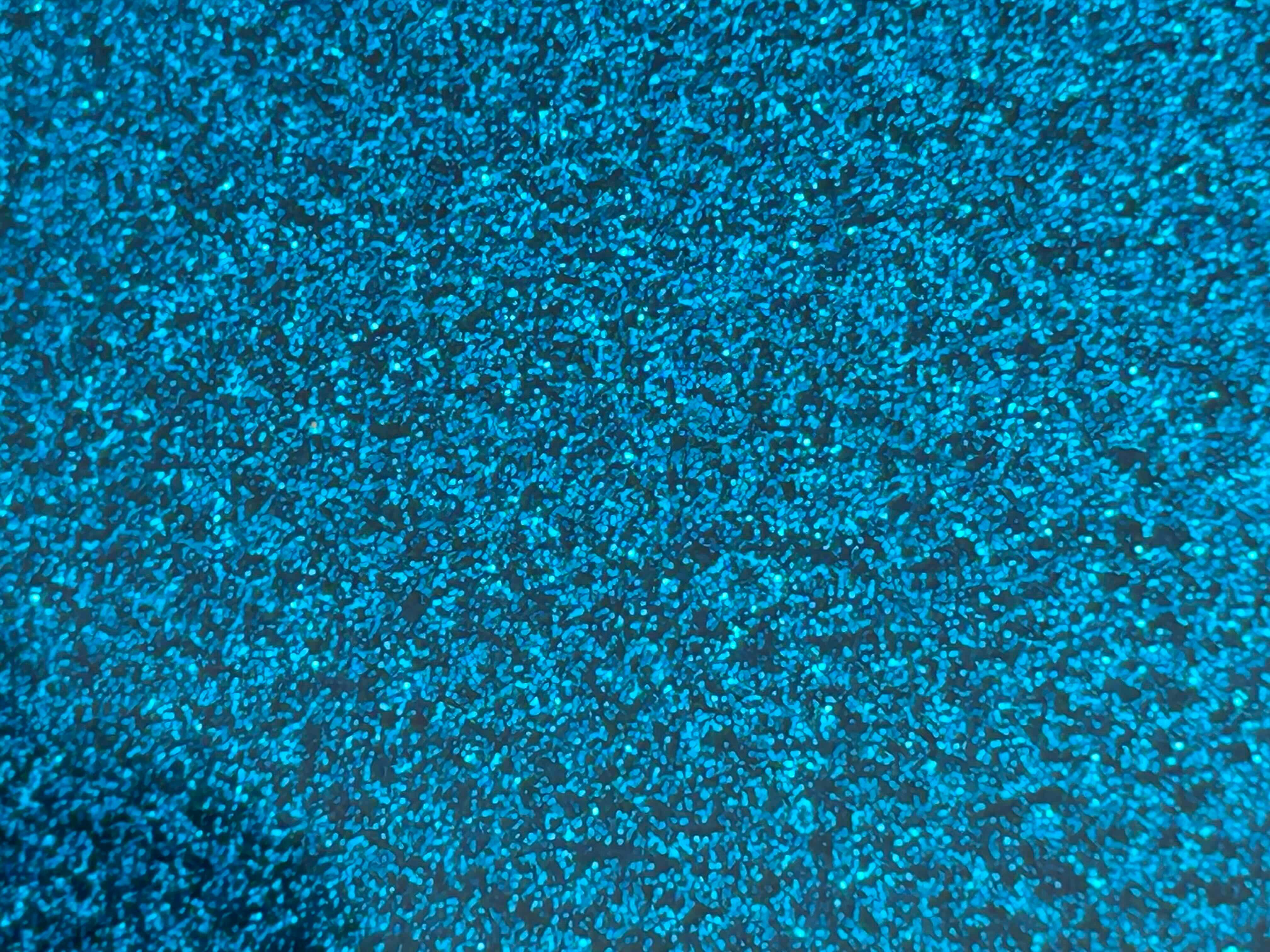 Close-up of a blue, glittery surface, possibly a boat hull.