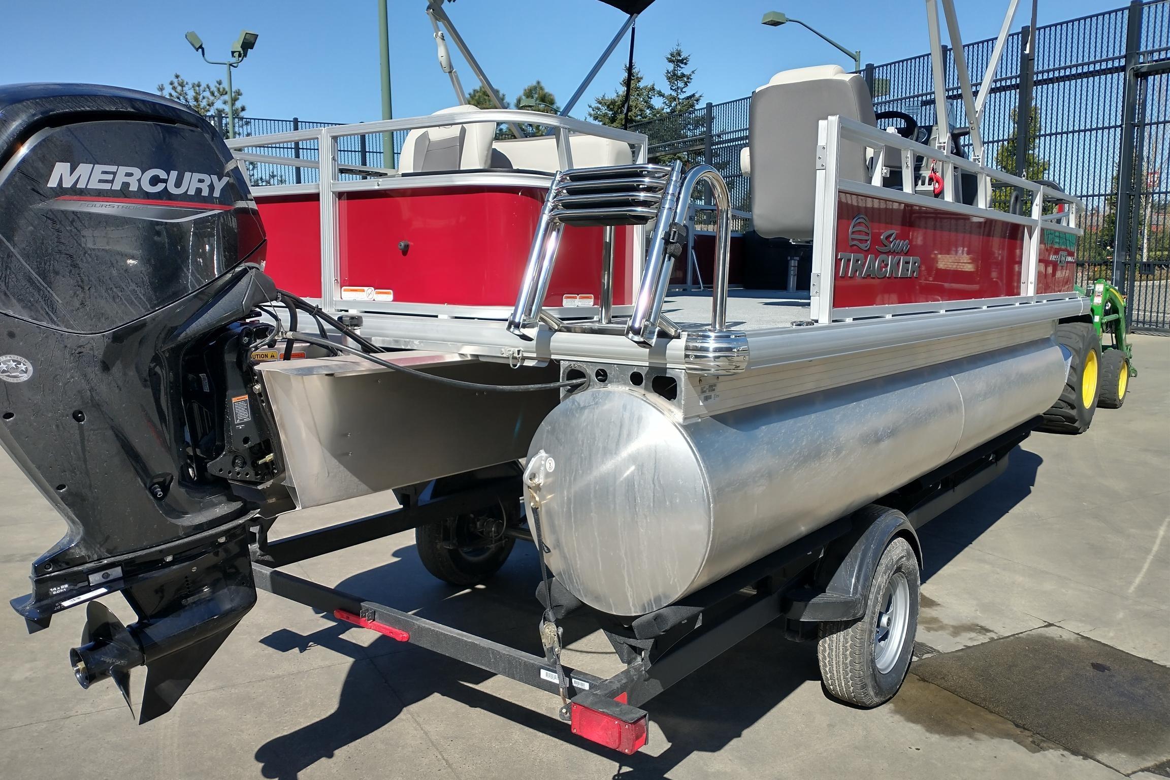 2026 Sun Tracker Bass Buggy 18 DLX pontoon boat with Mercury outboard motor on trailer.