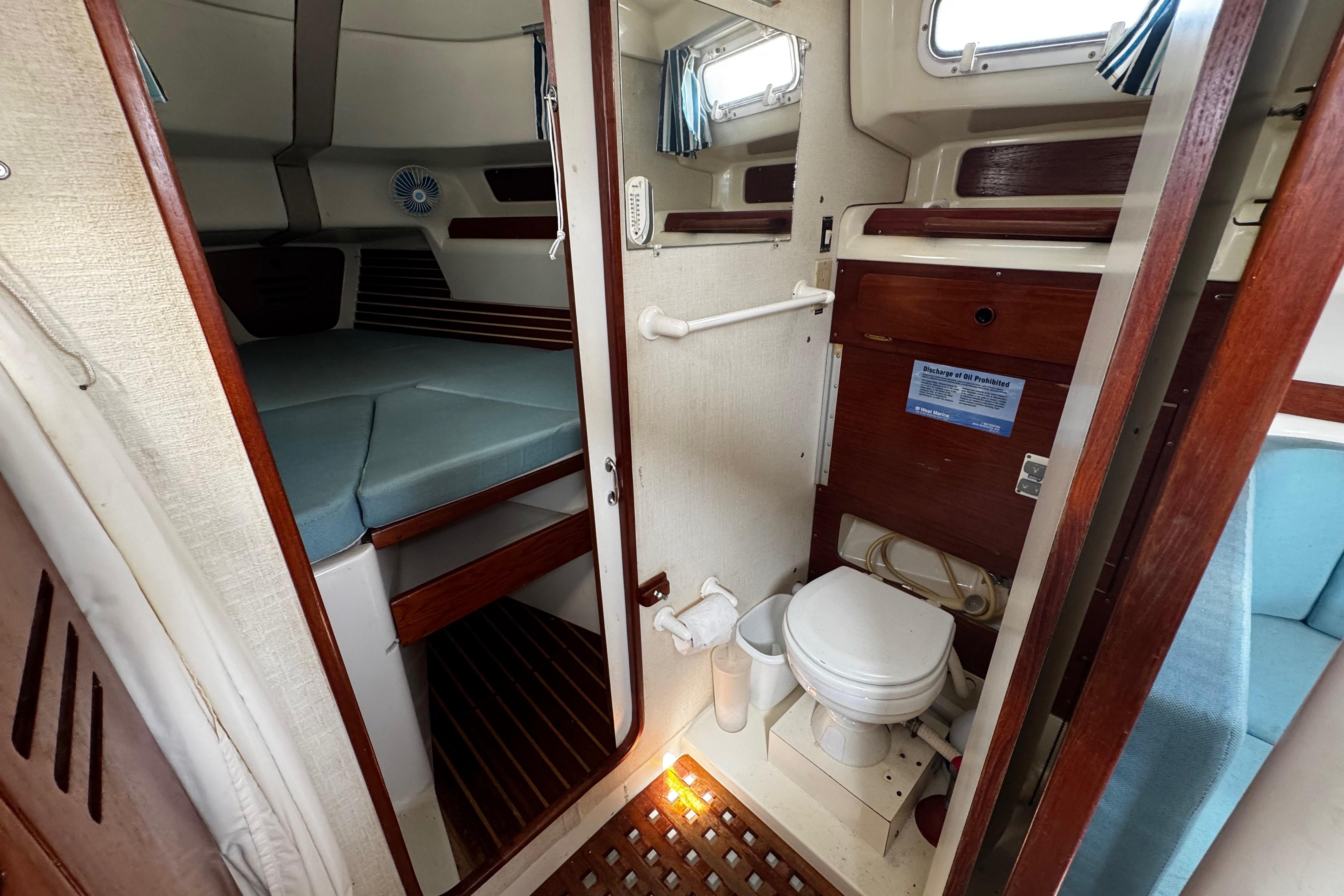1982 Pearson 323 yacht interior with cabin, toilet, and wooden accents.
