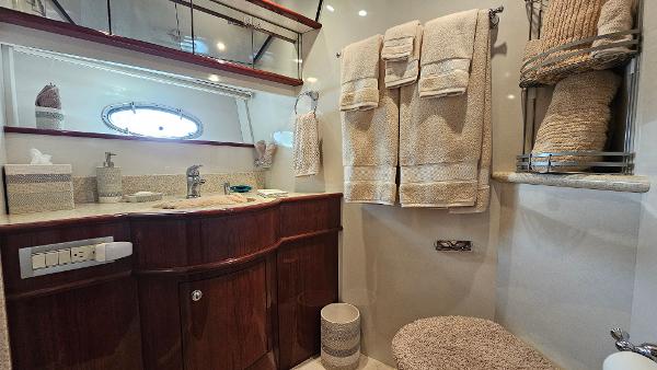 Luxurious bathroom in 2005 Neptunus 56 Flybridge yacht with elegant wood cabinetry.
