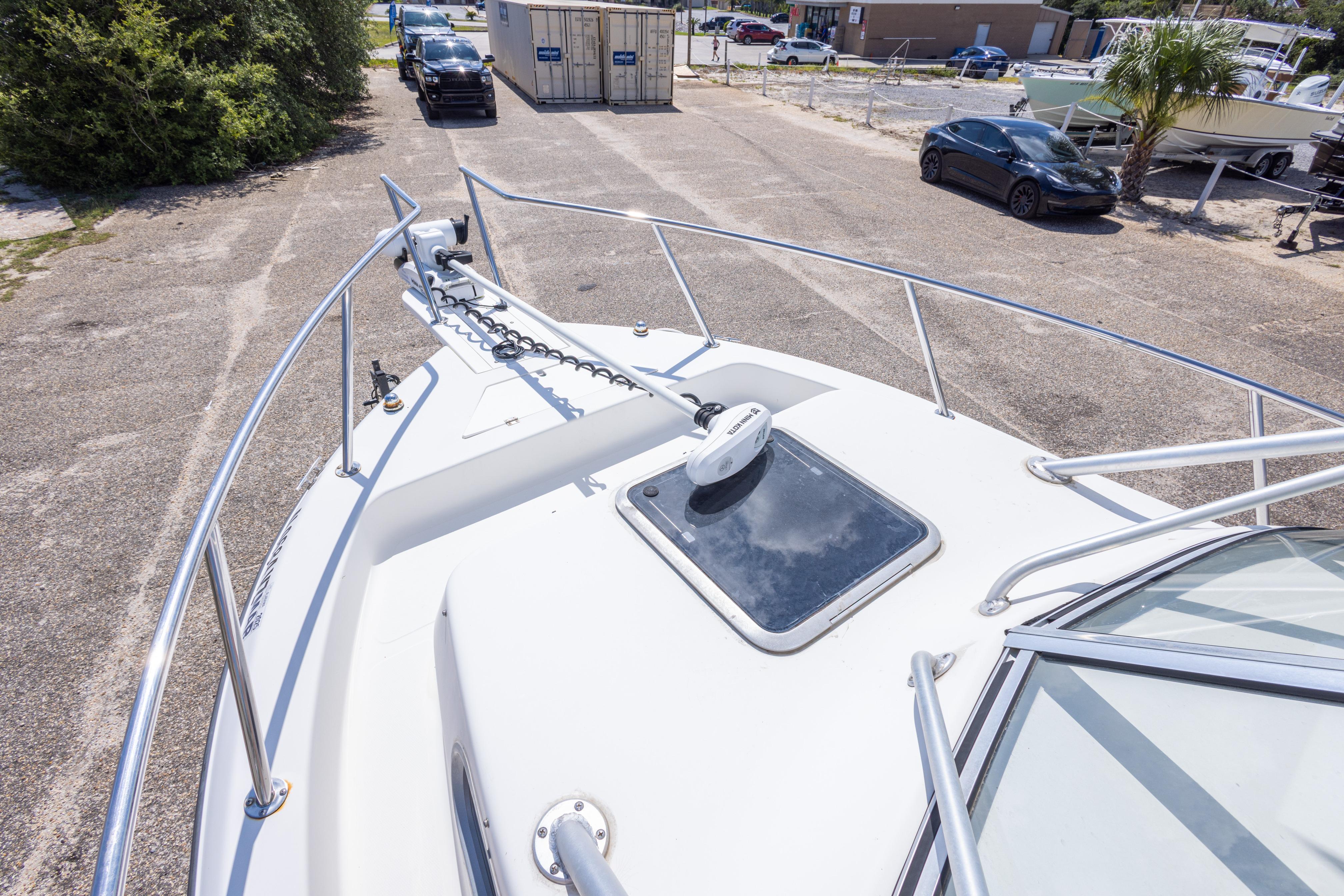 2007 Sea Boss 235 Walkaround boat deck with anchor and hatch, parked on a lot.