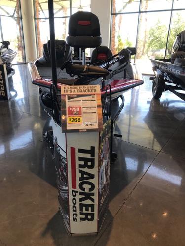 2025 Tracker Pro Team 175 boat displayed in showroom with promotional signage.