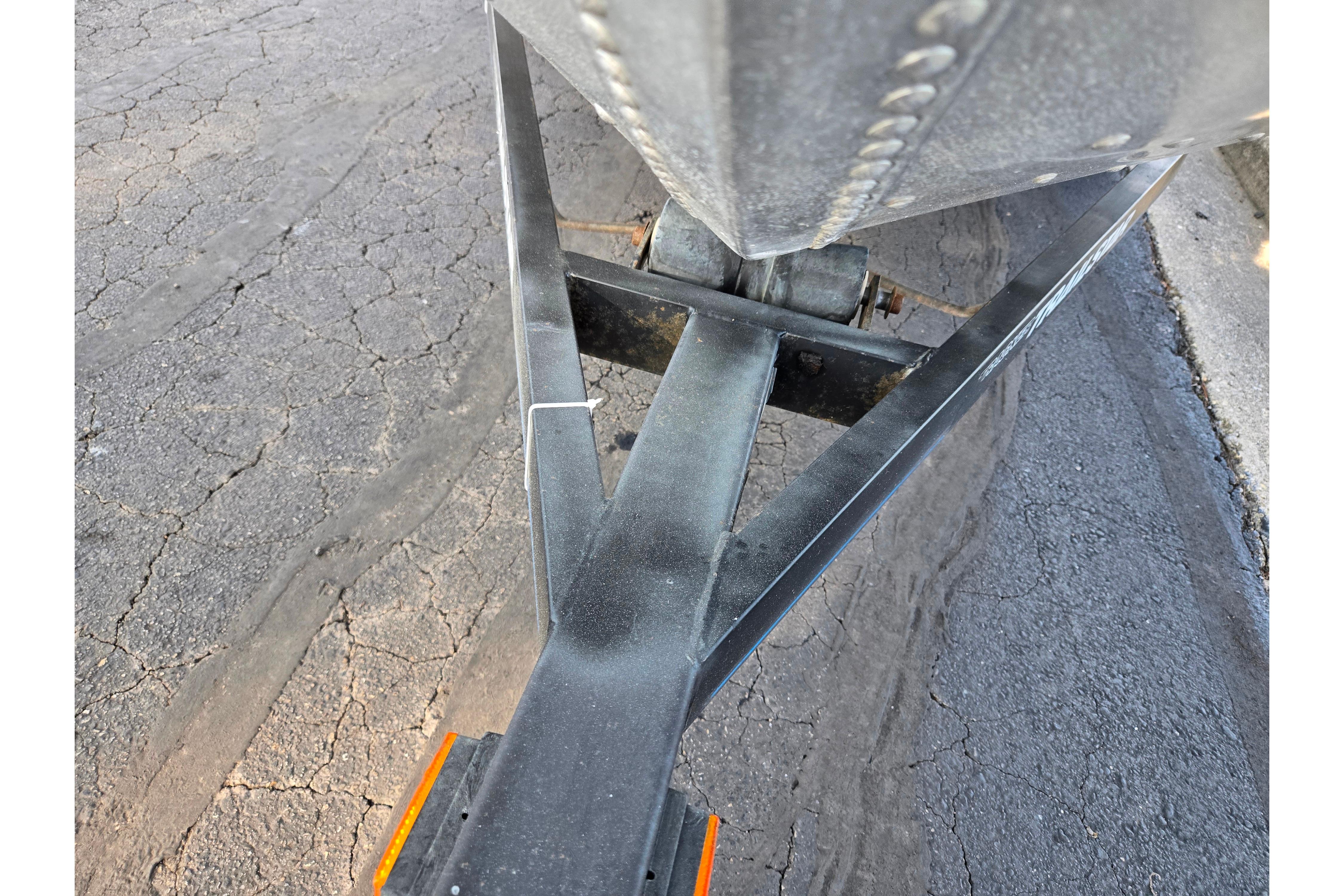 1994 Tracker Pro Deep V-16 boat trailer on cracked pavement.