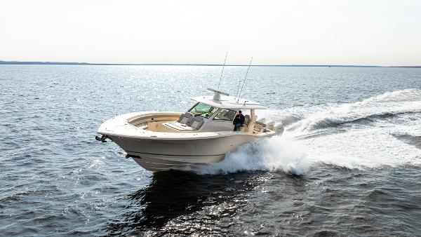 2025 Scout 425 LXF boat cruising on open water, showcasing sleek design and performance.