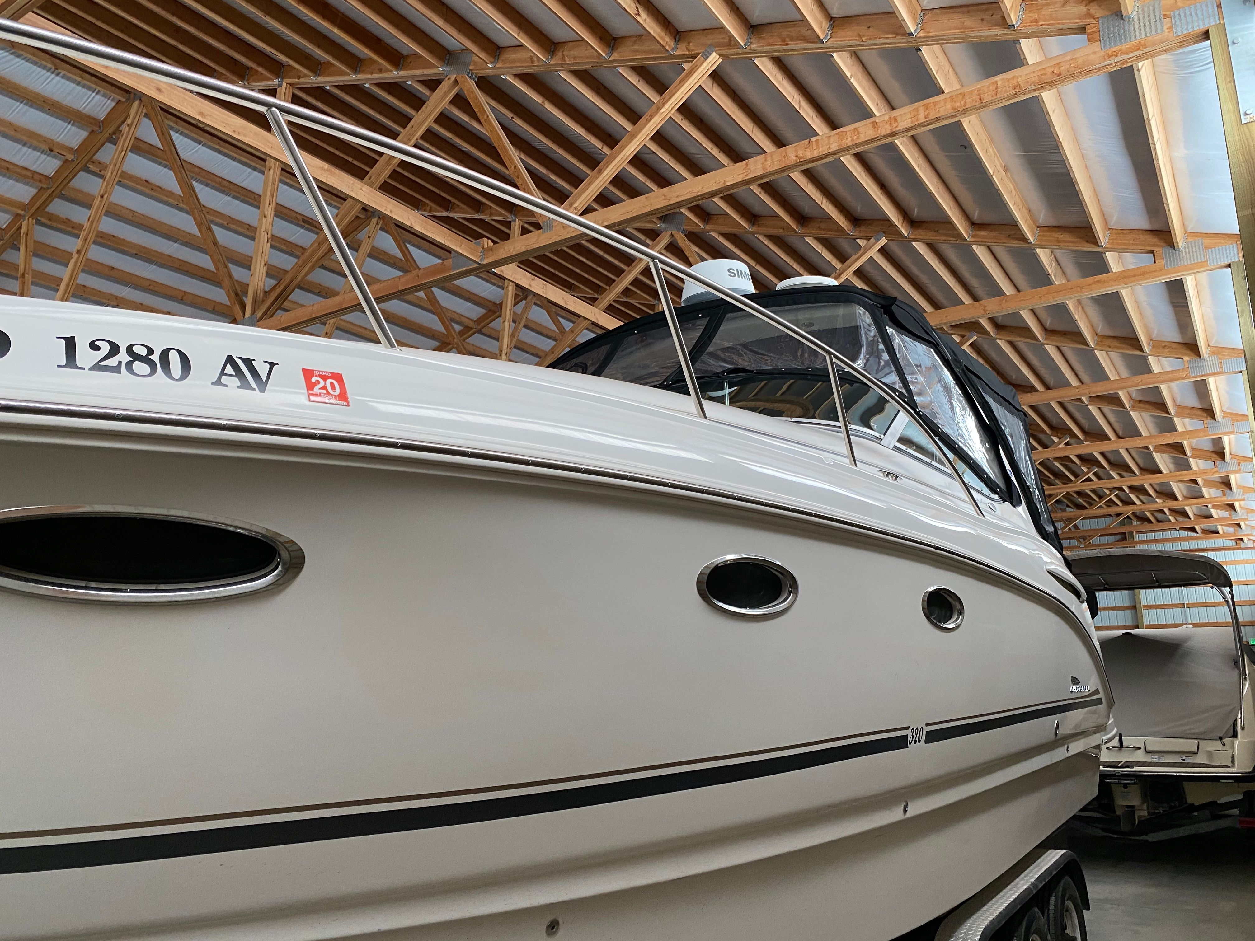 A 2004 Chaparral Signature 330 in a covered storage area. The boat features a sleek design.
