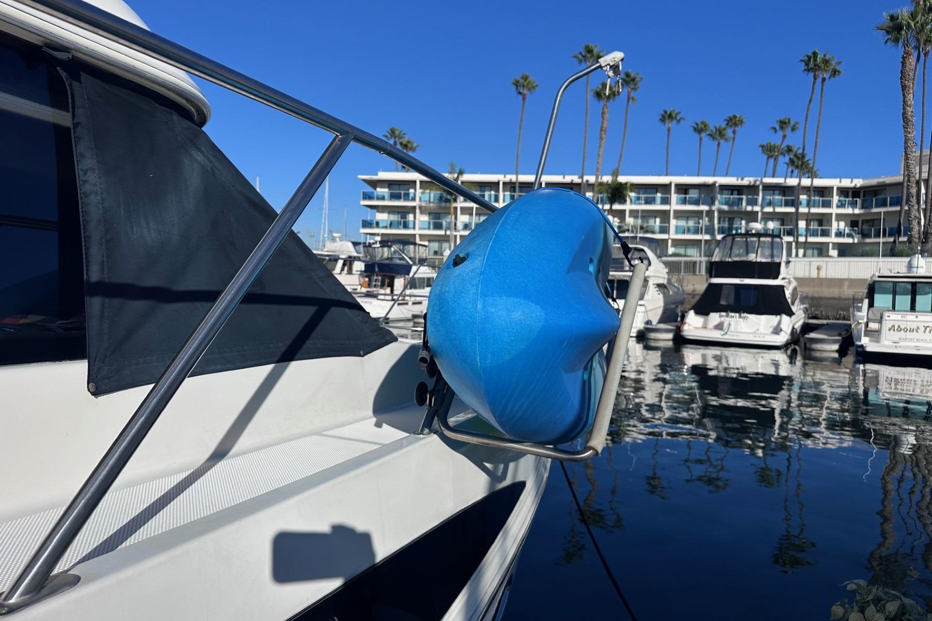 2004 Meridian 459 Motoryacht docked with blue fender, marina background.