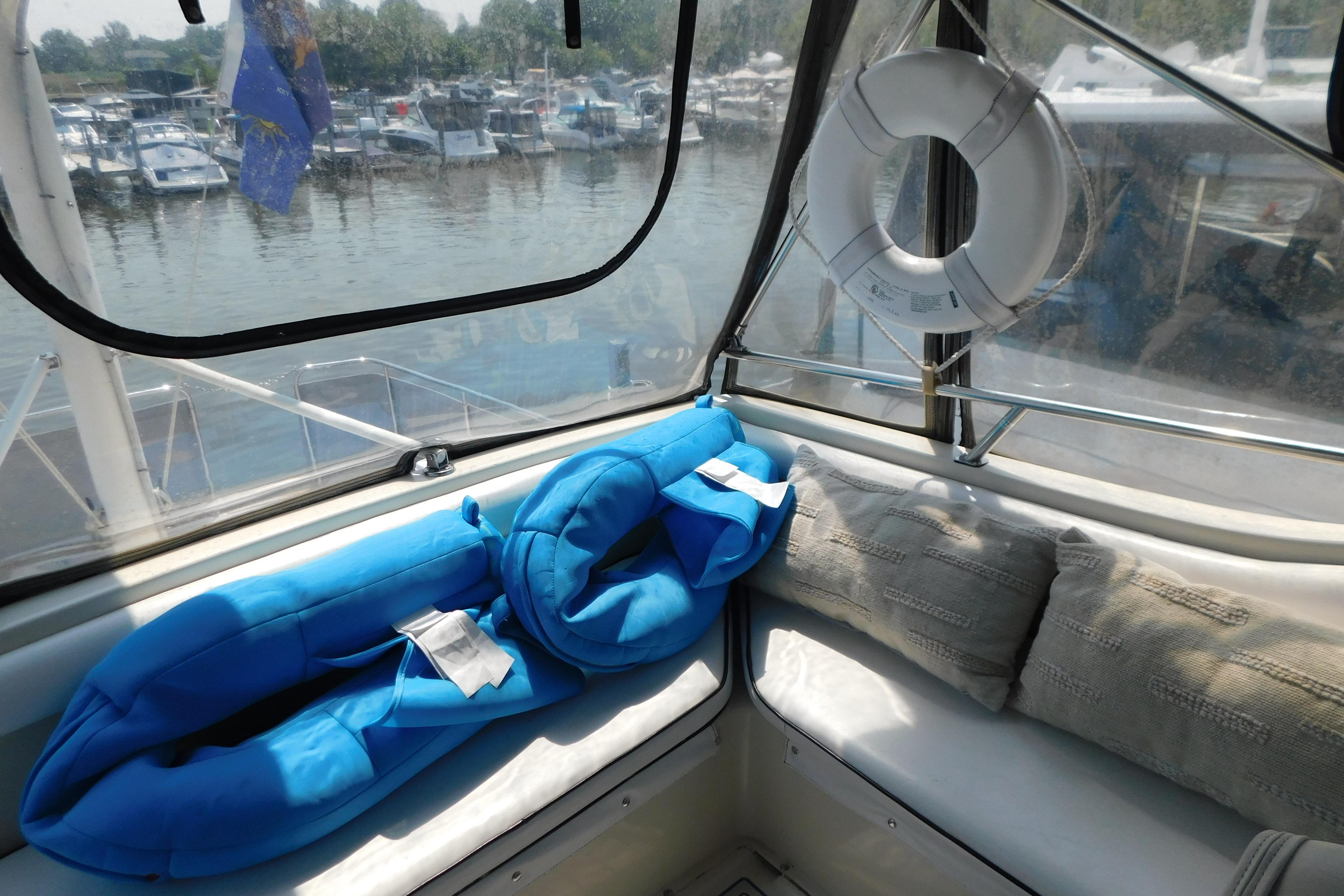 1987 Mainship 40 DC boat interior with blue life jackets and life preserver.