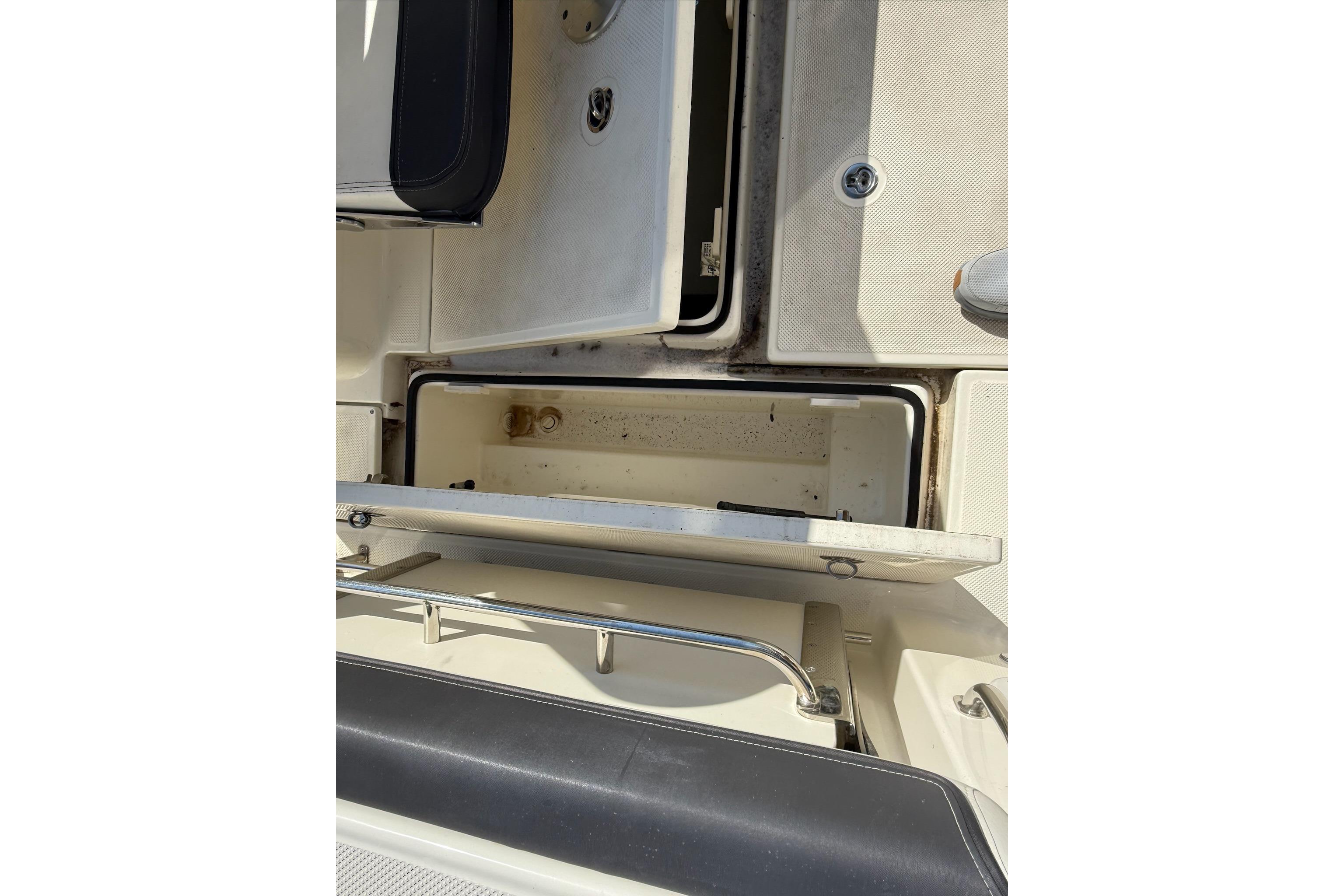 2024 Bayliner Trophy T25 Pilothouse storage compartment with open hatch.