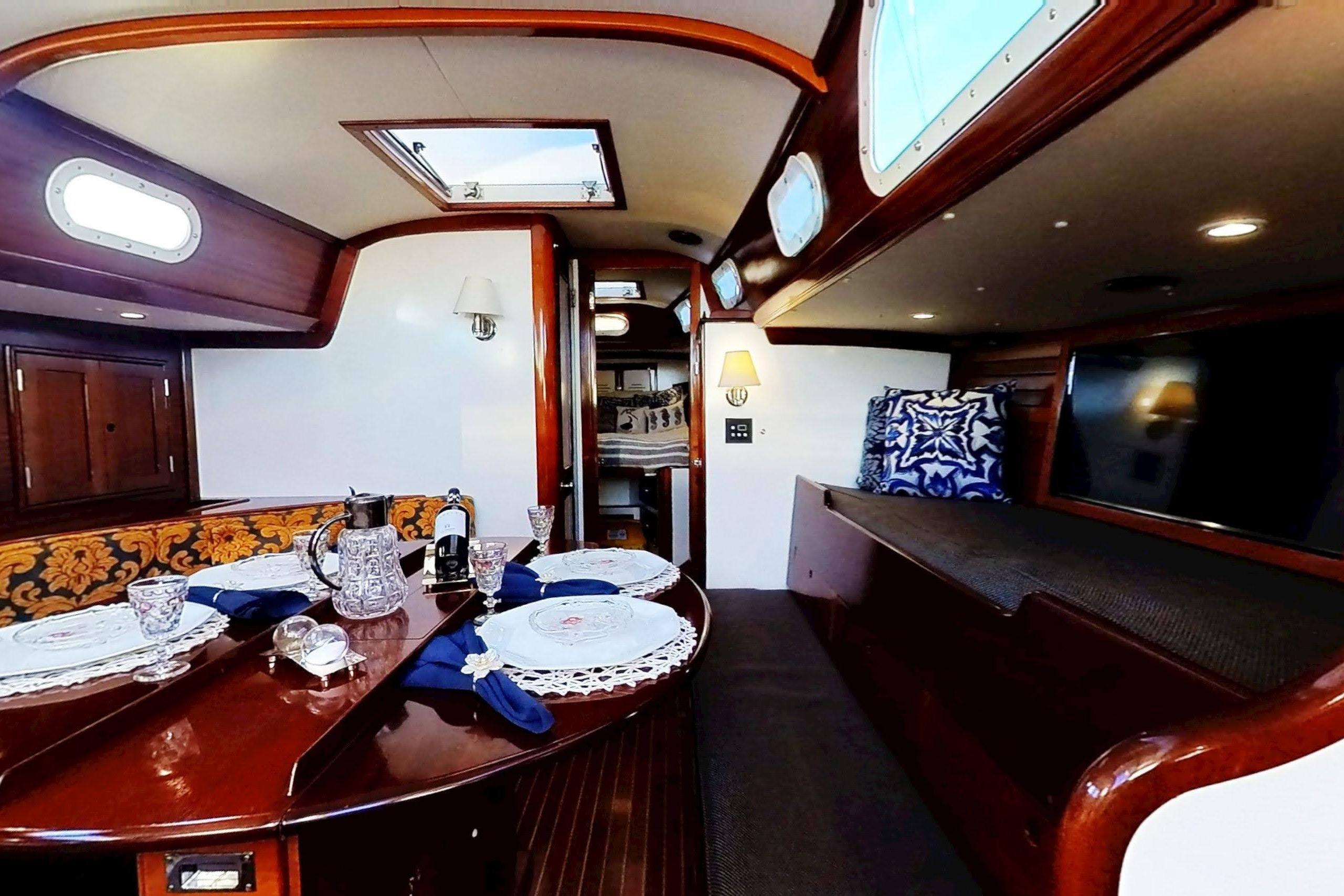 Interior of a 1970 Hinckley Bermuda 40 yacht with elegant dining setup.