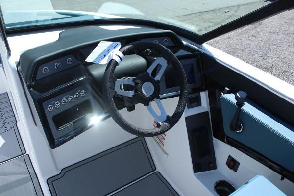2025 MasterCraft NXT21 boat cockpit with modern steering wheel and control panel.