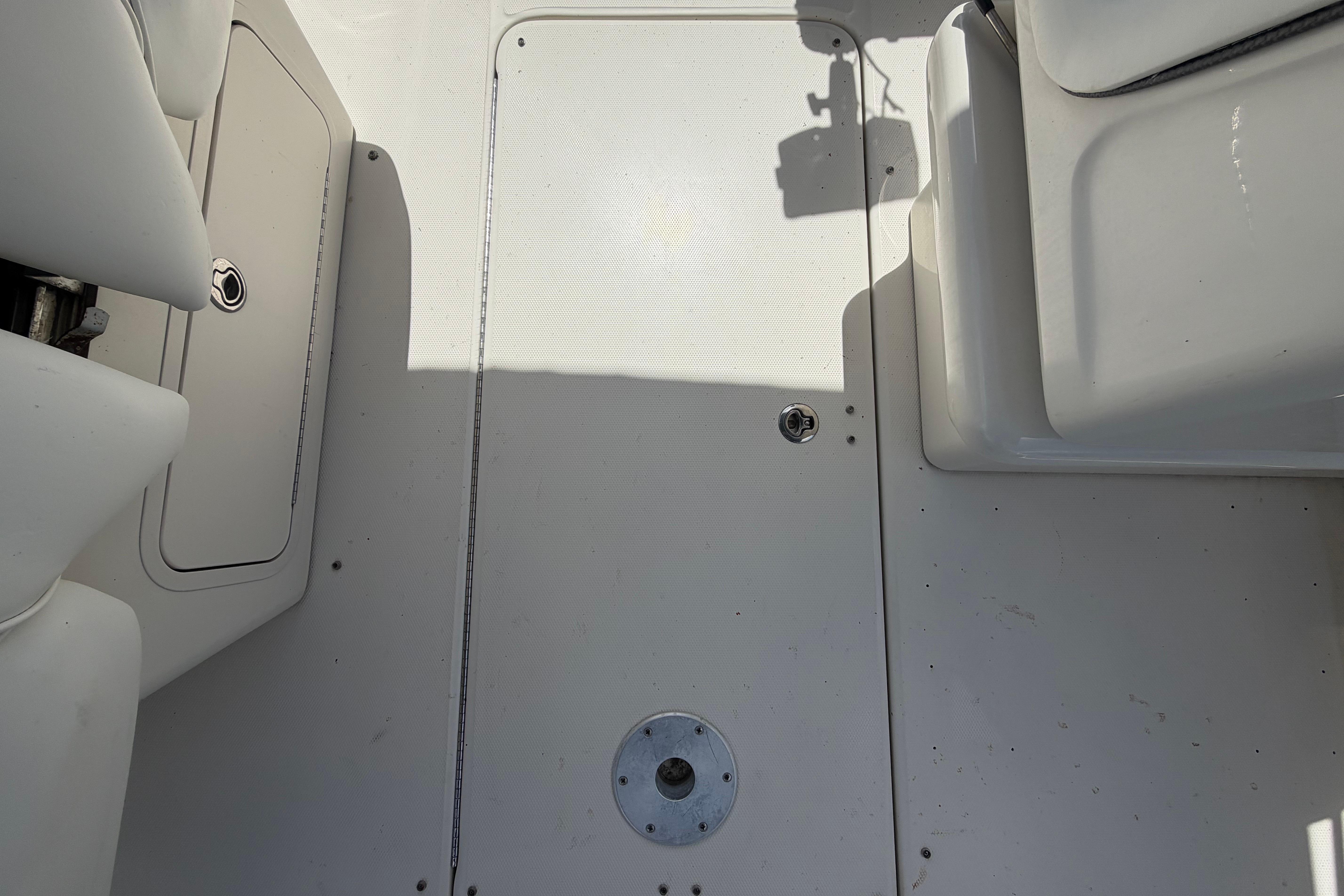 2006 Sea Ray 250 Amberjack boat deck with storage compartments and seating.