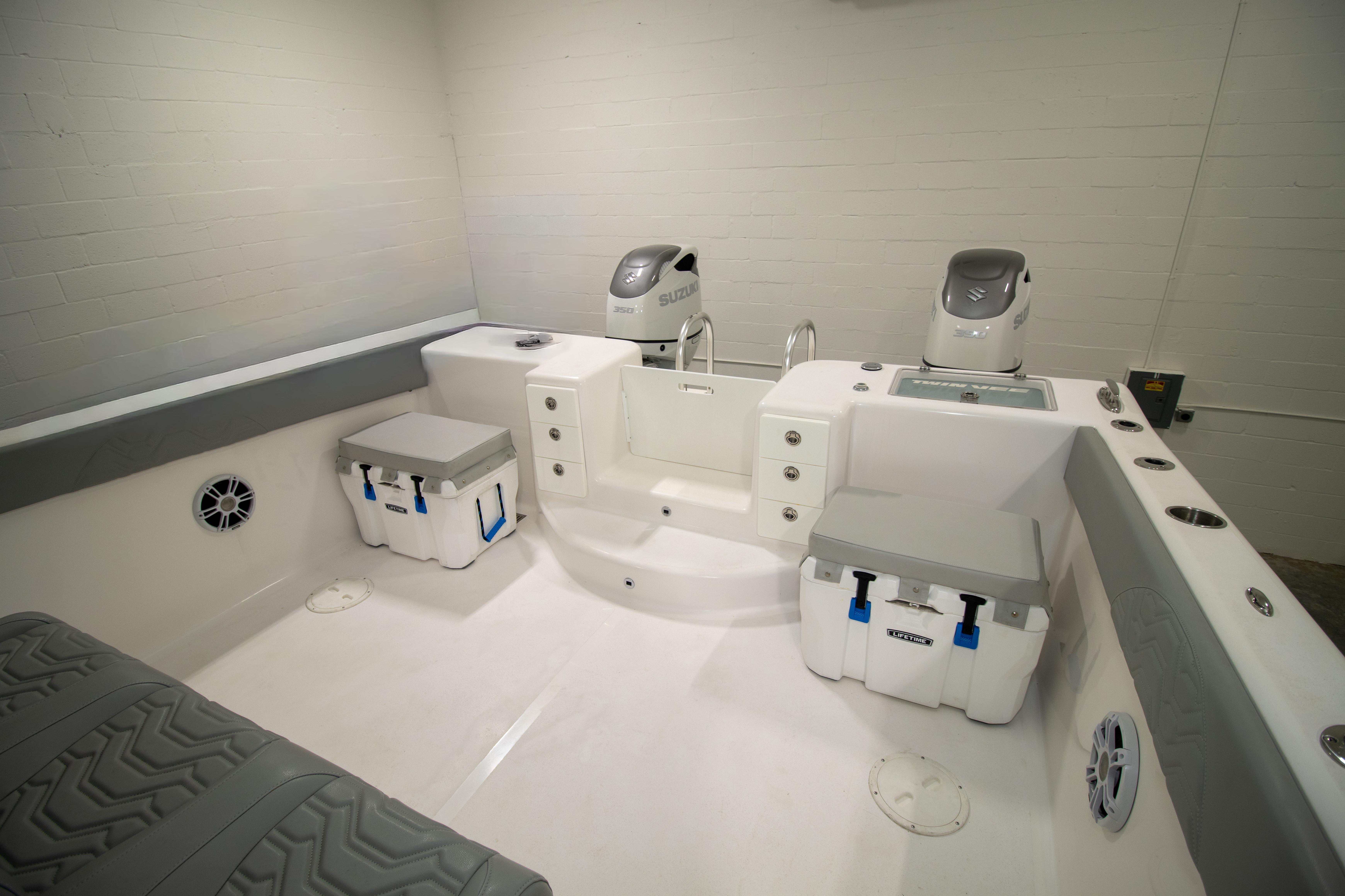 2023 Twin Vee 340 GFX CC boat interior with Suzuki engines and storage coolers.