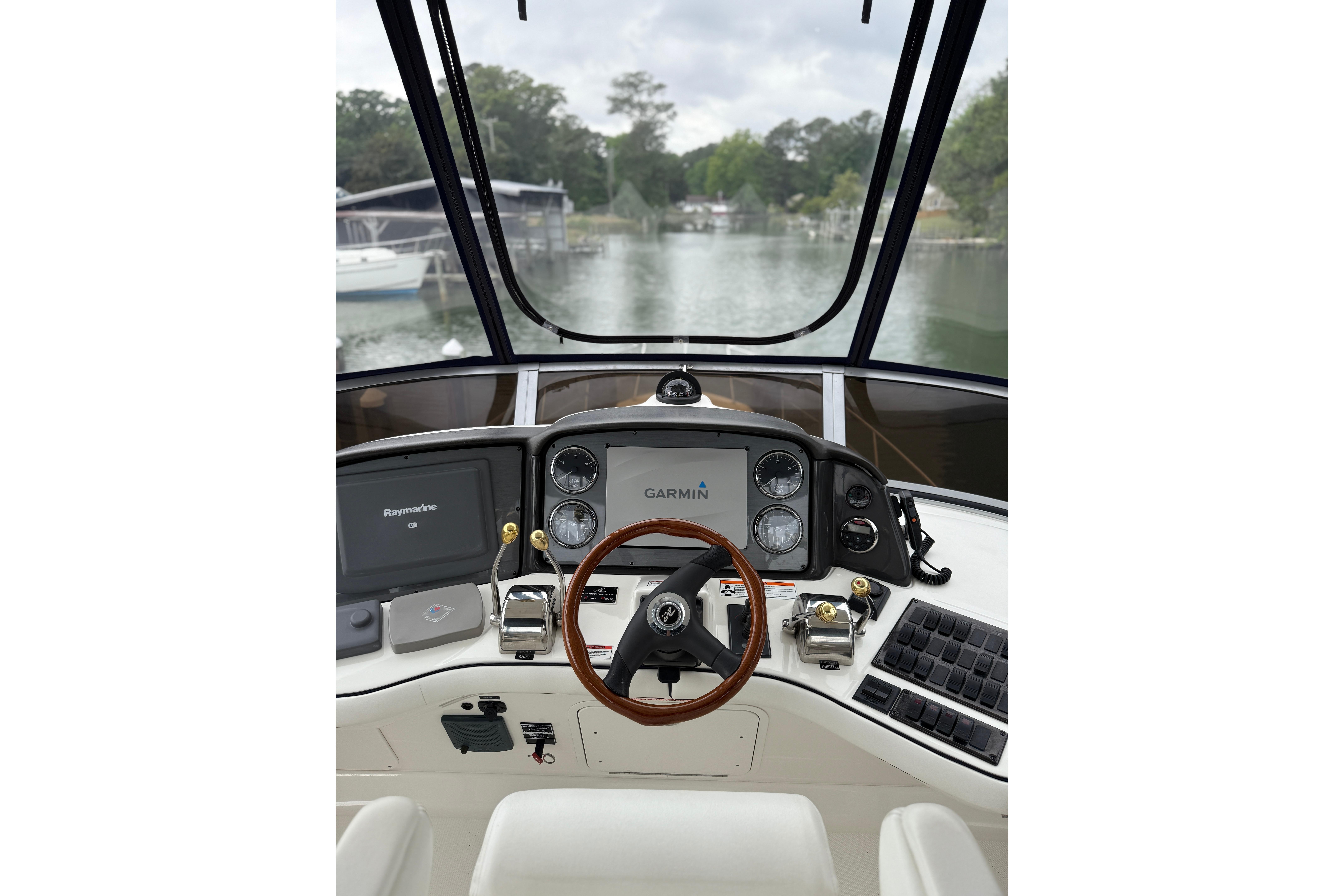 2007 Sea Ray 44 Sedan Bridge helm with Garmin and Raymarine navigation systems.