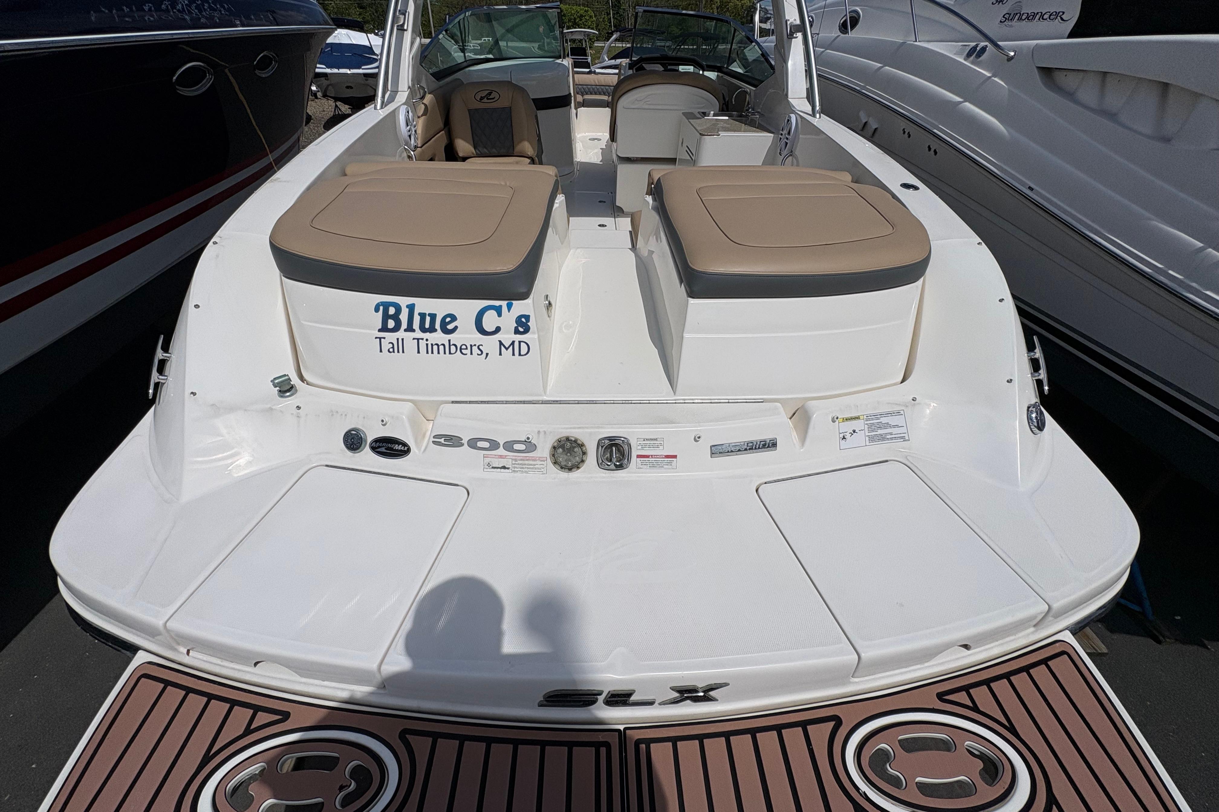 2015 Sea Ray 300 SLX boat docked, featuring tan seating and "Blue C's" lettering.