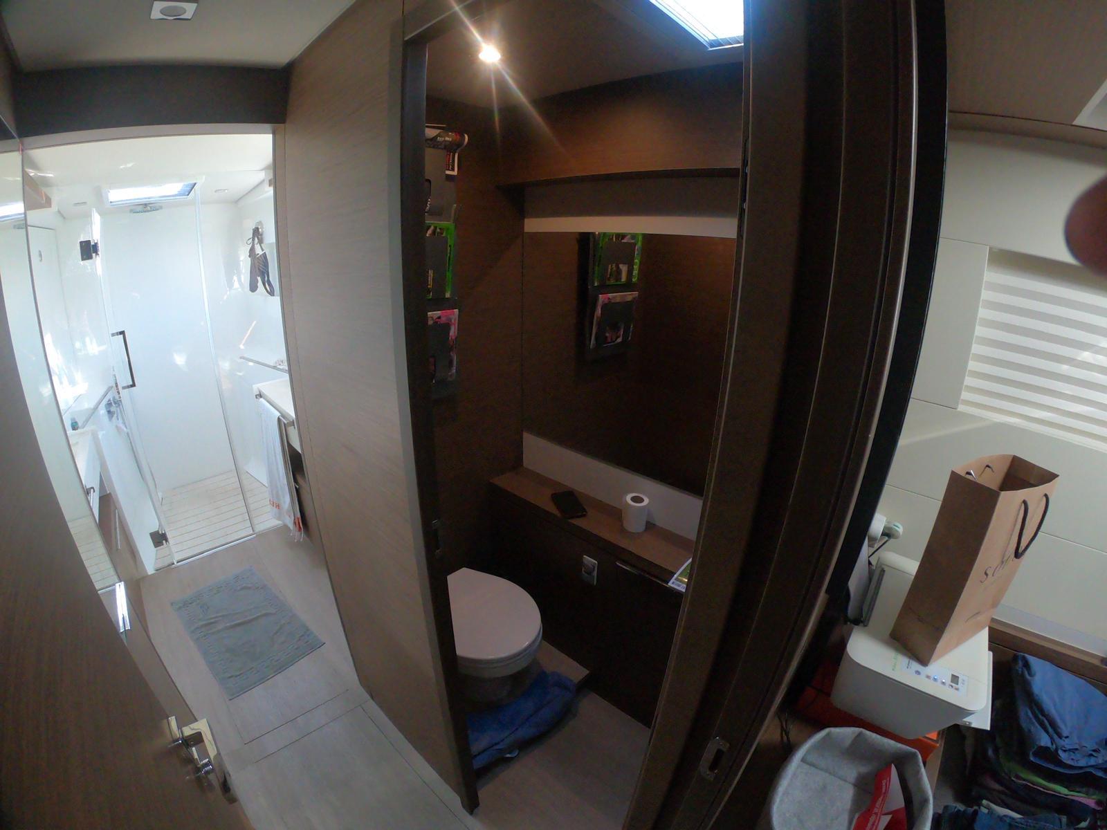 Bathroom interior of a 2019 Lagoon 50 yacht, featuring modern fixtures and storage.