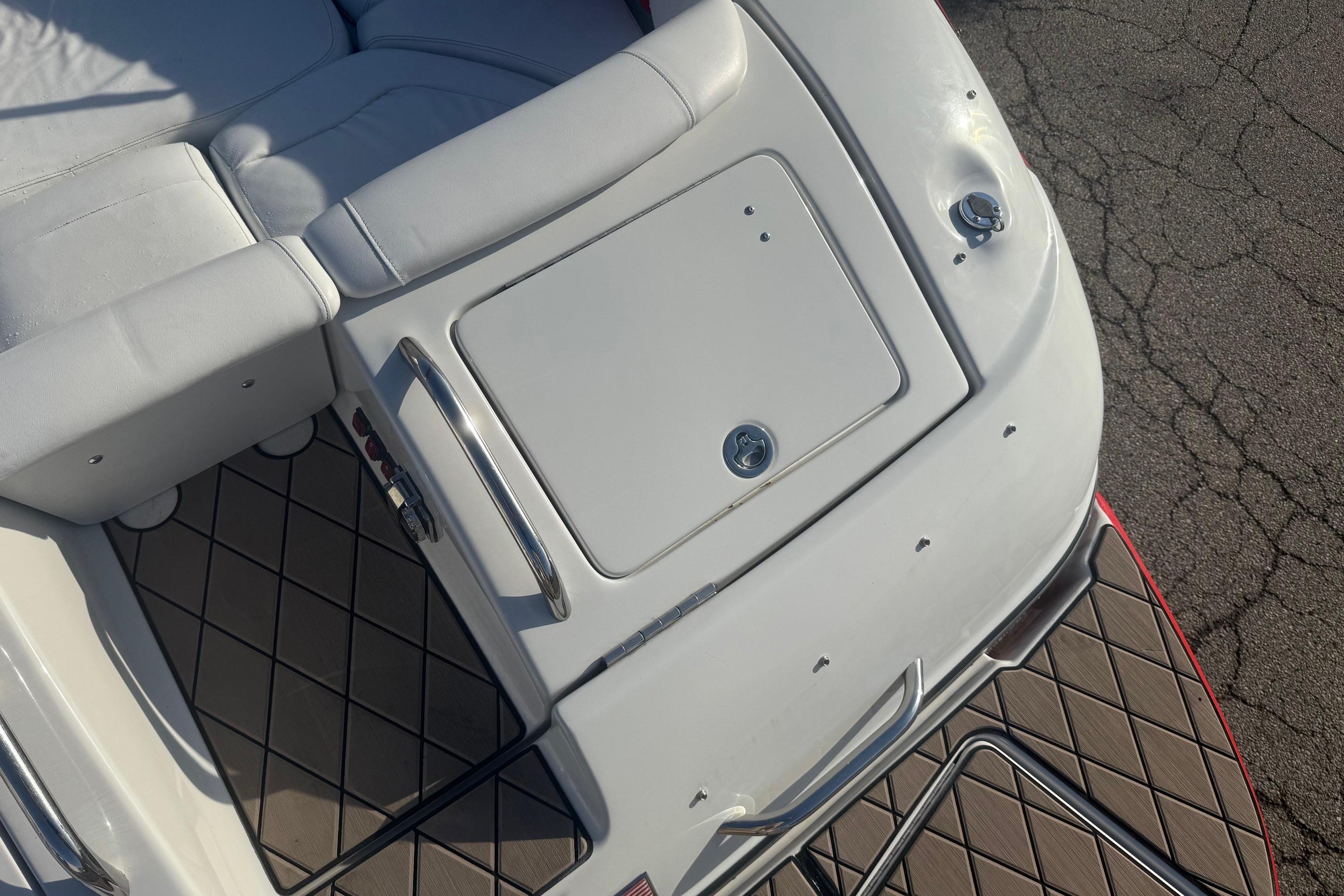 2005 Crownline 270 BR boat interior with white seating and storage compartment.
